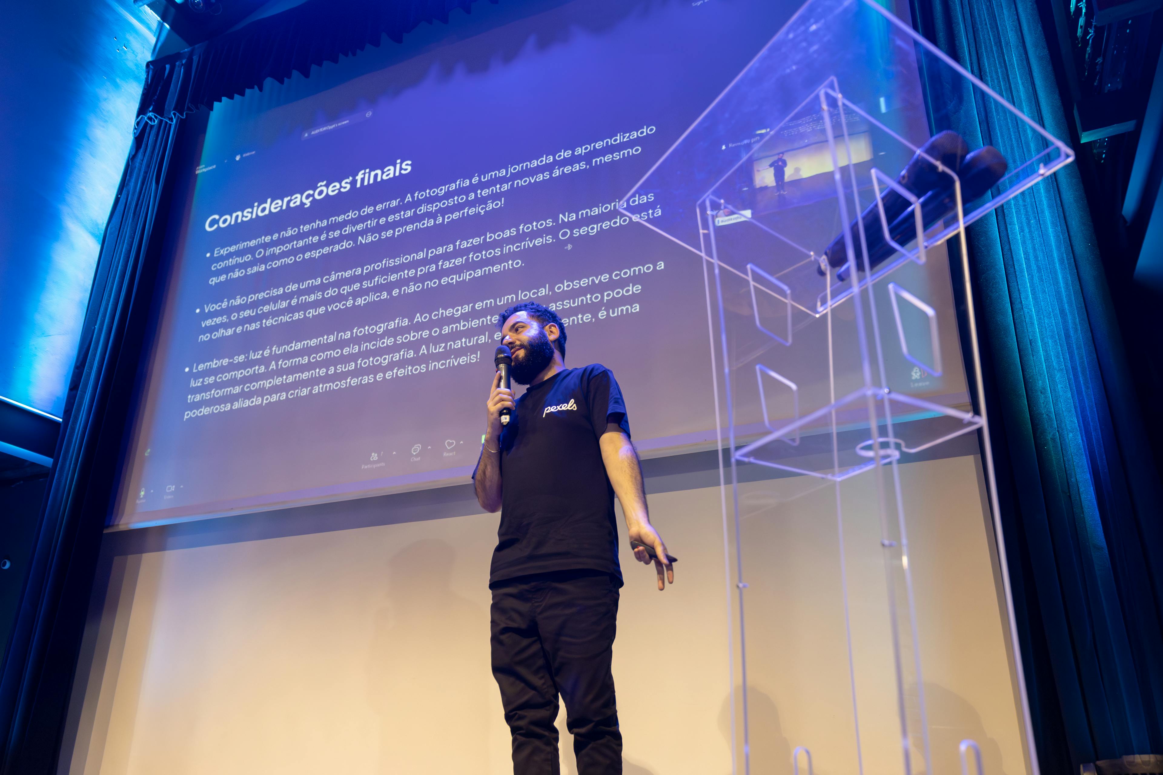 A speaker engaging an audience at a public event representing the visibility and reputation of the 10th house