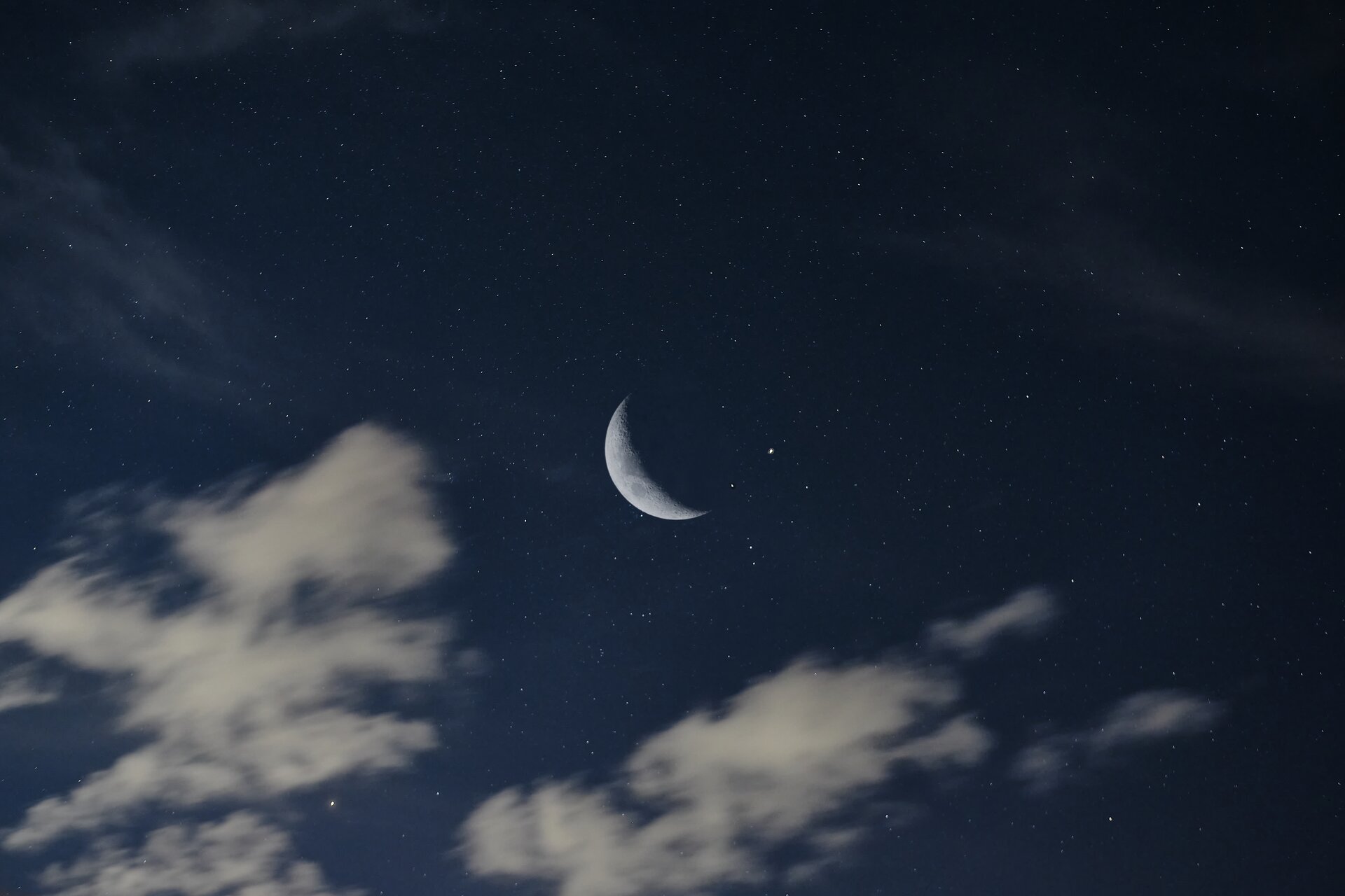 A starry night sky with a glowing moon, representing the nighttime writing session of the 369 method