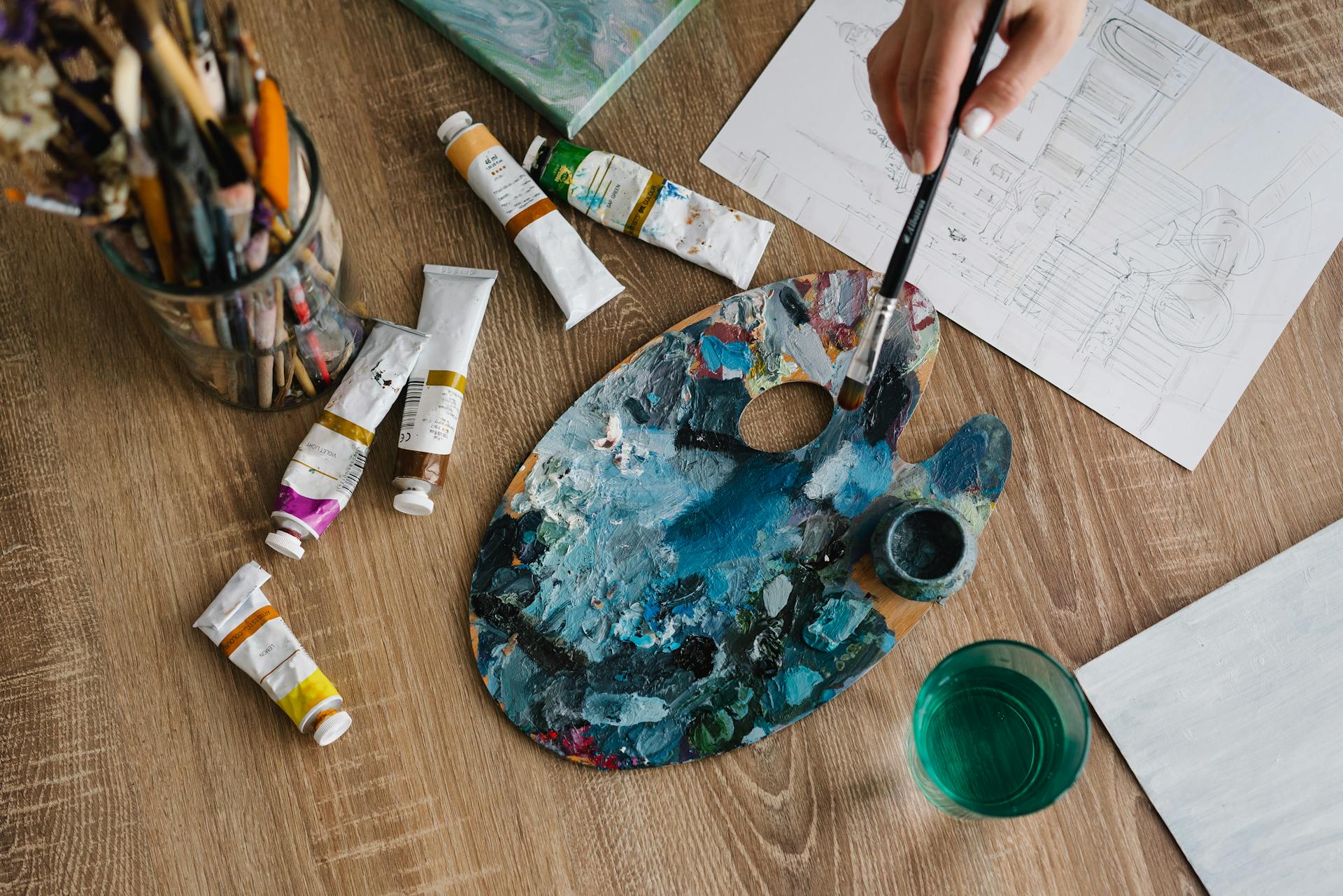Art studio with brushes paint tubes and palette ready for creative work representing 5th house artistic expression