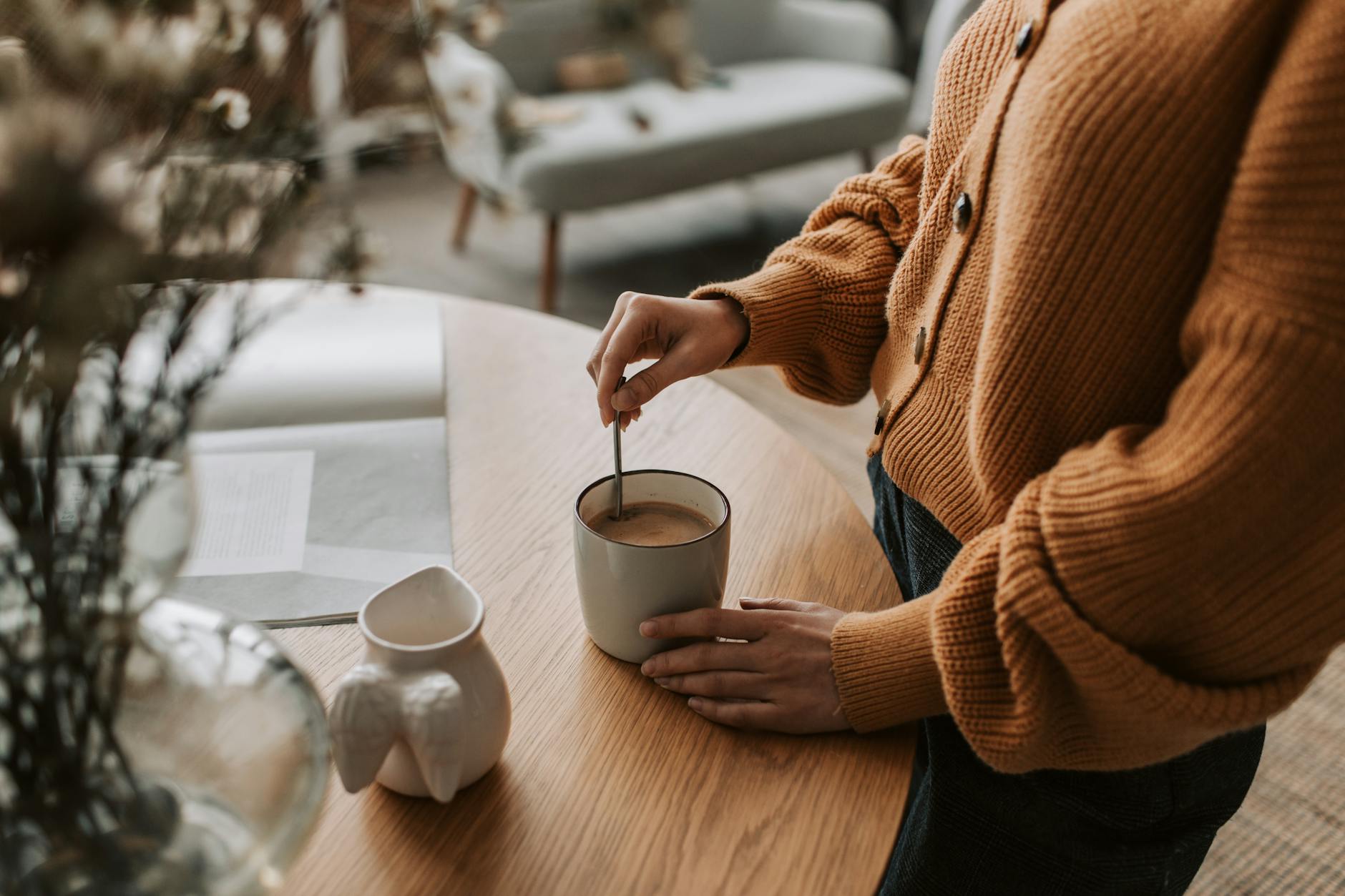 A warm morning coffee and notebook on a wooden table representing the daily rituals ruled by the 6th house