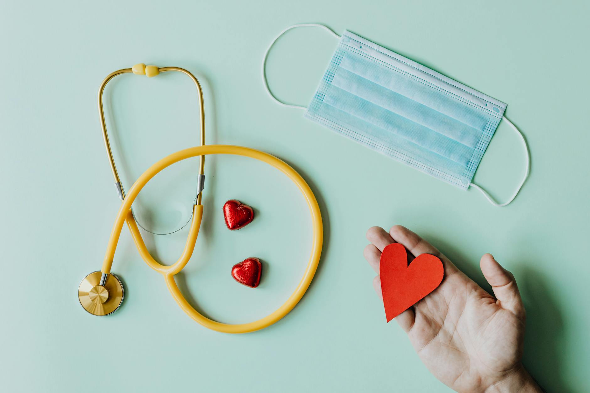 A stethoscope and notebook on a wooden surface illustrating the health themes ruled by the 6th house