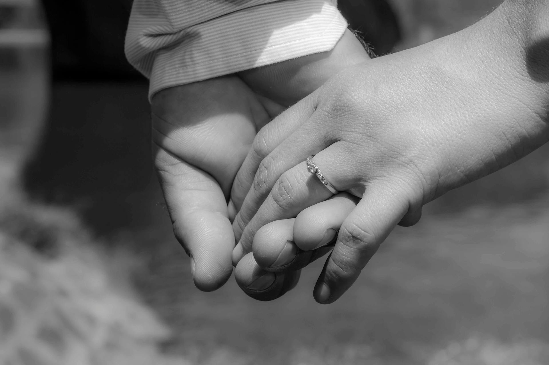 Two hands close together with soft light representing the meeting of selves in 7th house partnership