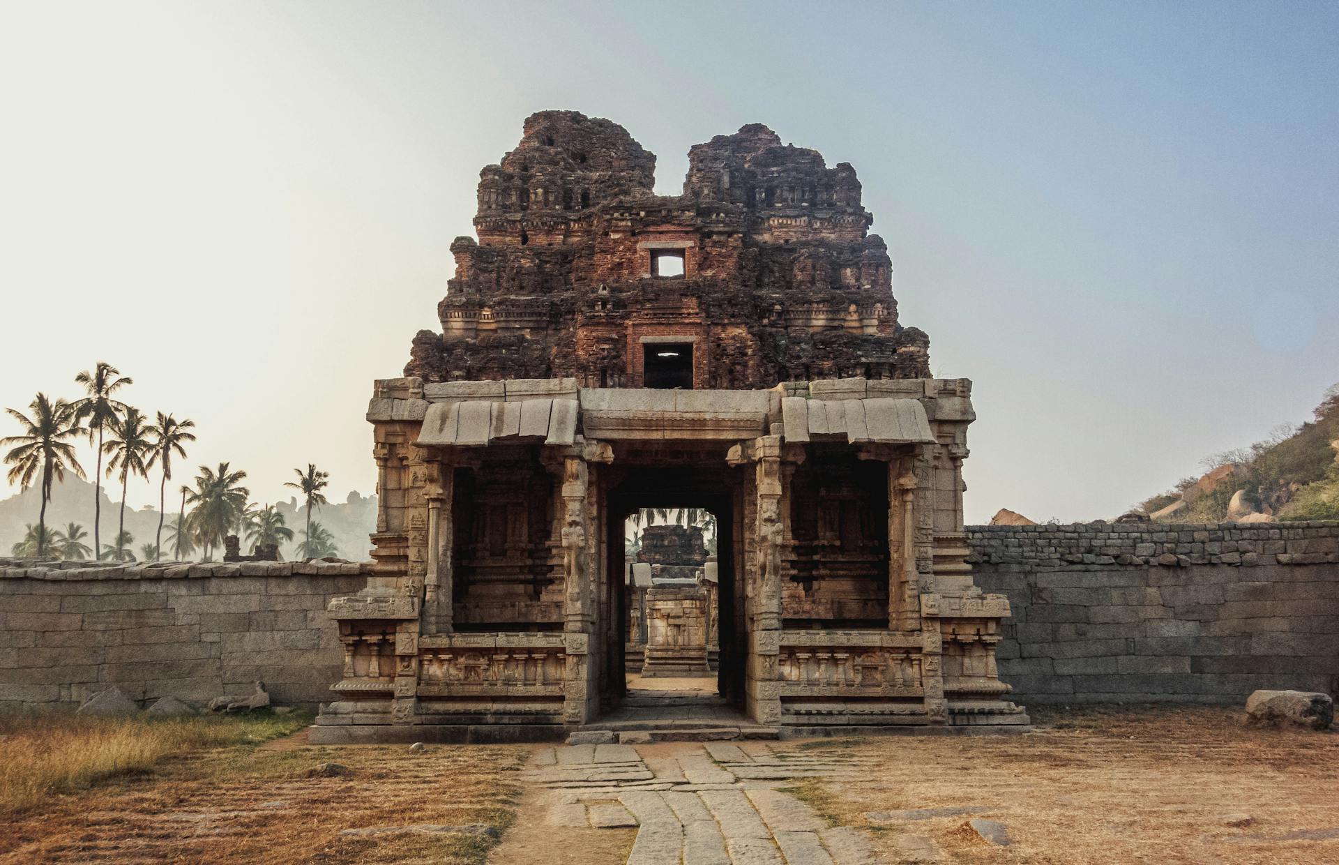 Ancient stone temple at sunrise representing the spiritual and philosophical territory of the 9th house