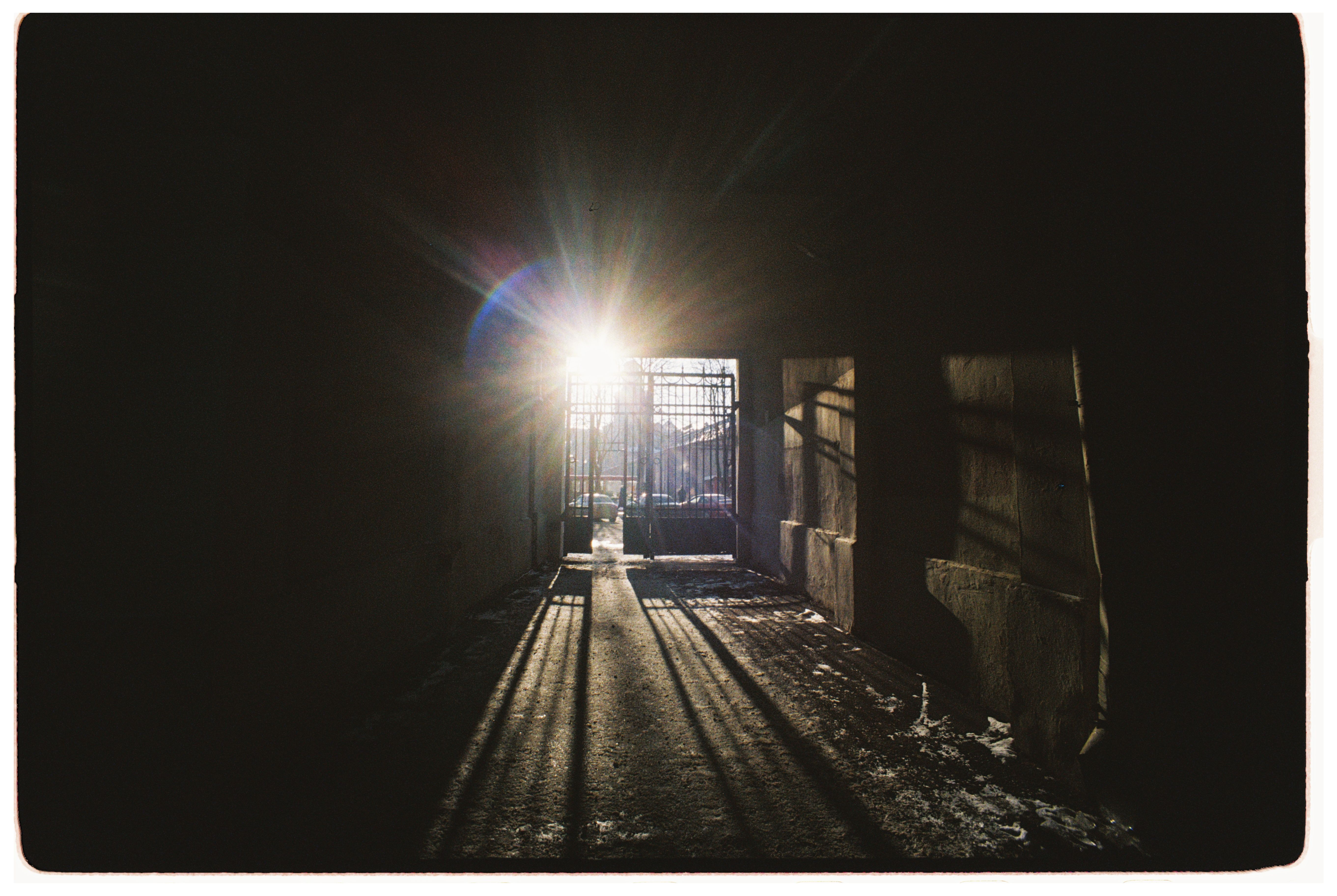 An open door with light spilling through onto a path at sunrise, representing the fresh start angel number 1010 points toward