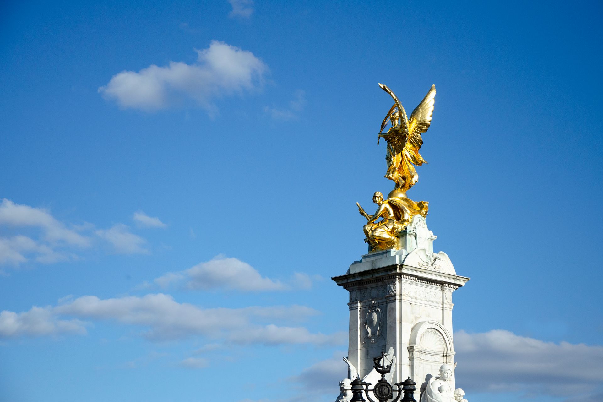 A stone angel statue lit by soft light against an open sky, symbolizing the meaning of angel number 111
