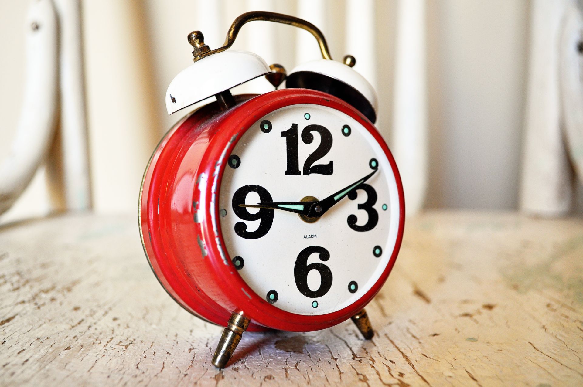 Vintage alarm clock on a wooden surface, symbolizing the moment you notice 11:11 on the clock