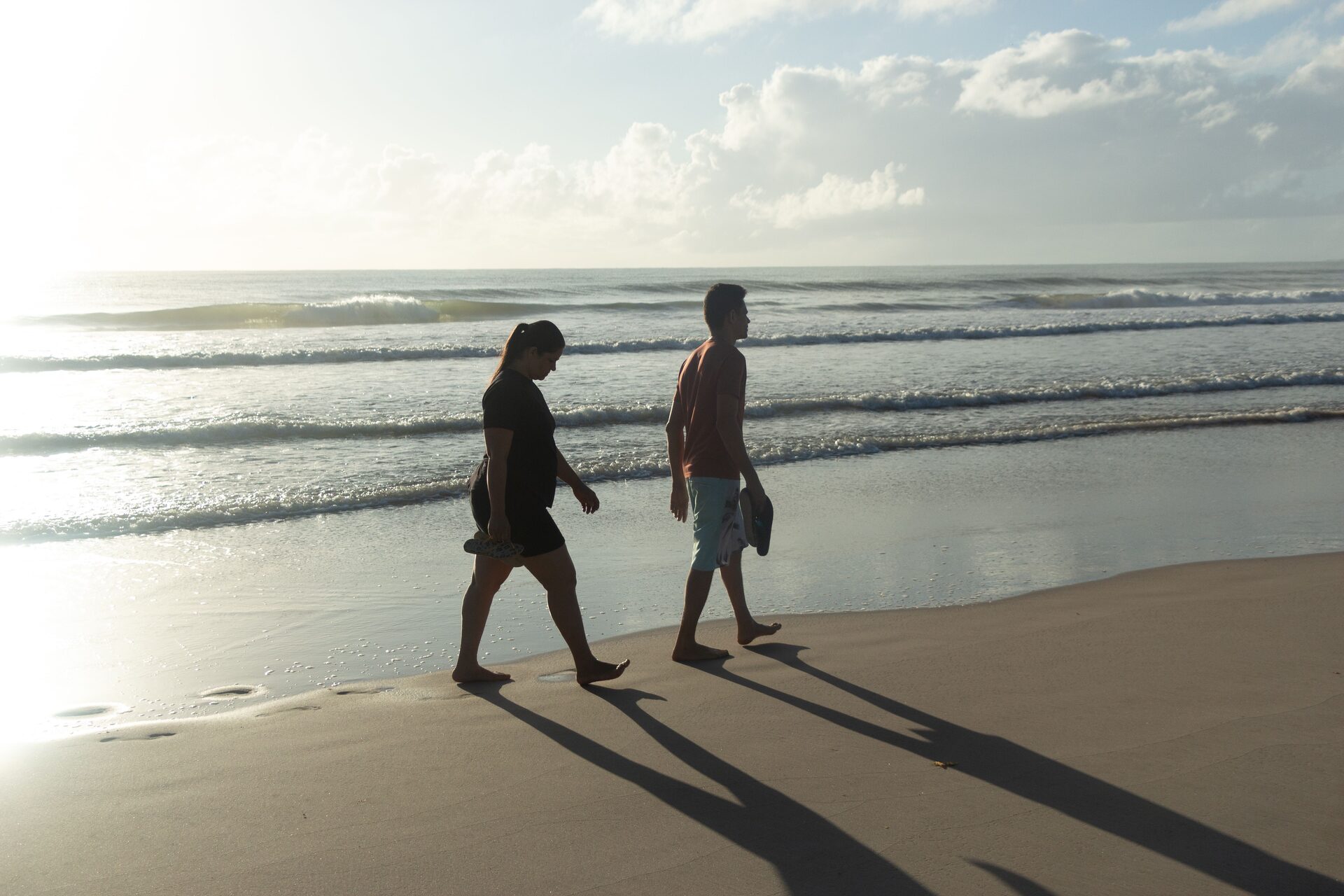 A couple walking together along a quiet path at sunrise, symbolizing the balanced, growing relationship energy connected to angel number 1212
