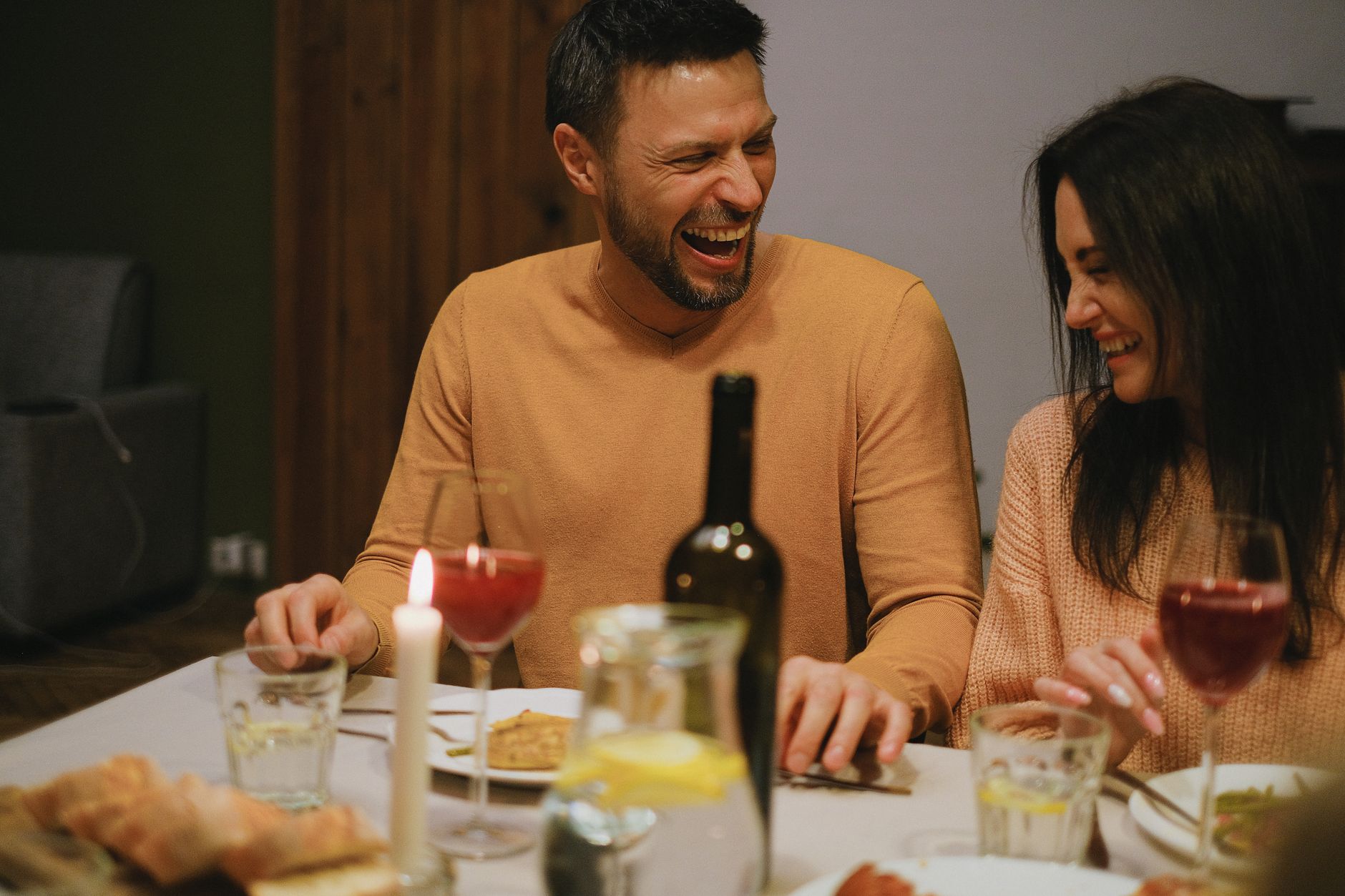 A happy couple laughing together outdoors, symbolizing the growth, joy, and open communication connected to angel number 333