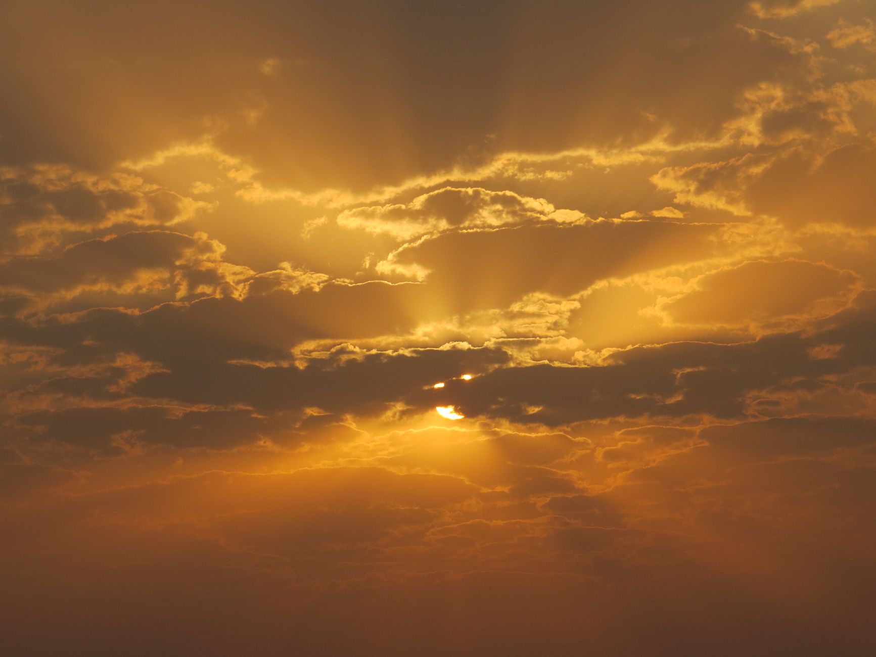 Golden sun rays breaking through an open sky, representing the creative, expansive energy of the number 3 in numerology