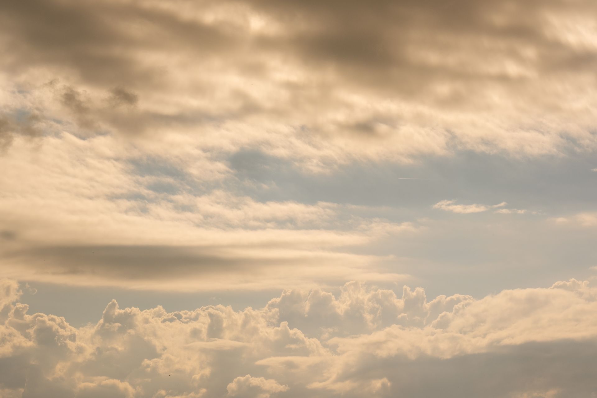 Golden light spilling through layered clouds, representing the grounded, supportive energy of the number 4 in numerology