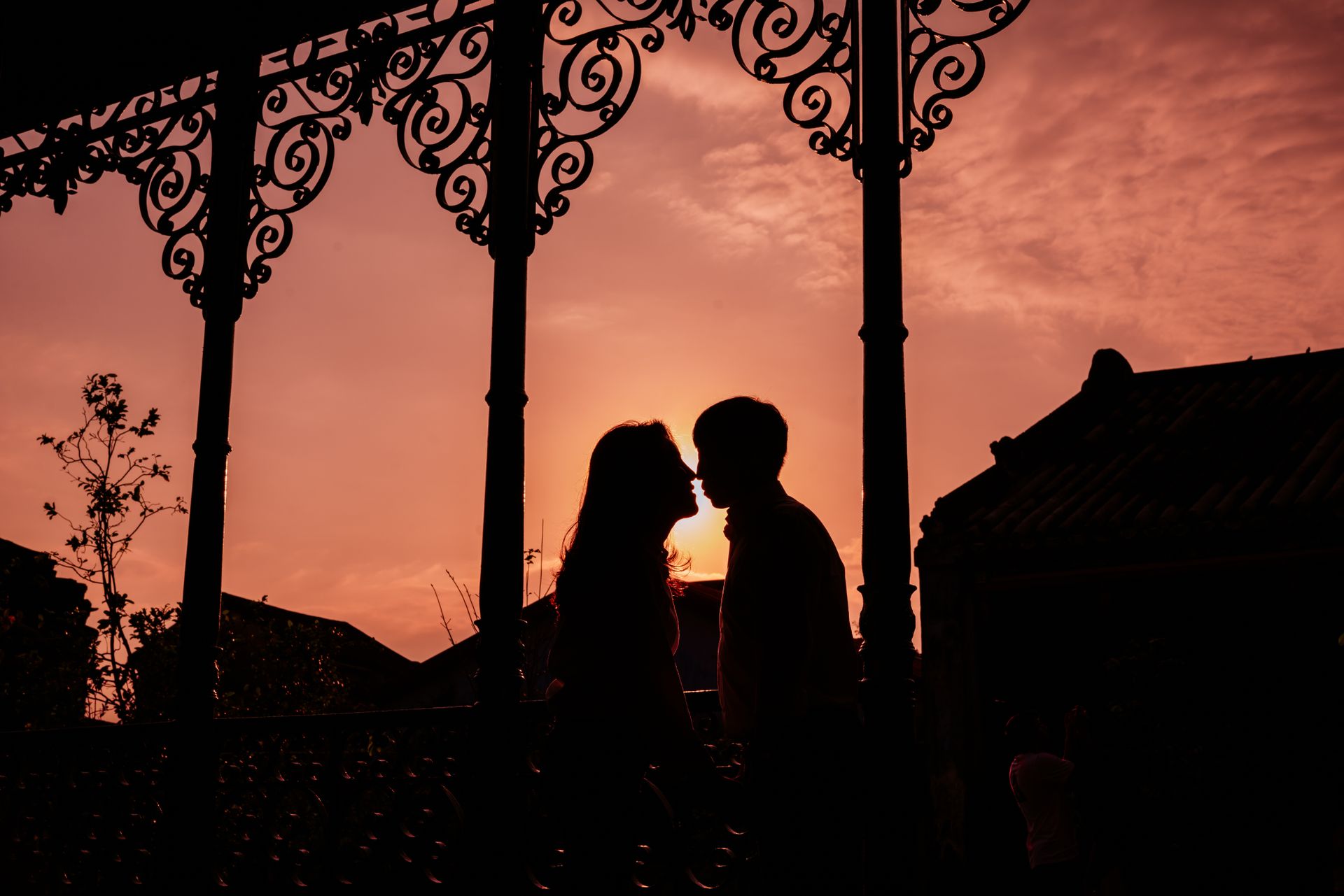 A silhouetted couple sharing an intimate moment at sunset, symbolizing the shifting relationship energy connected to angel number 555