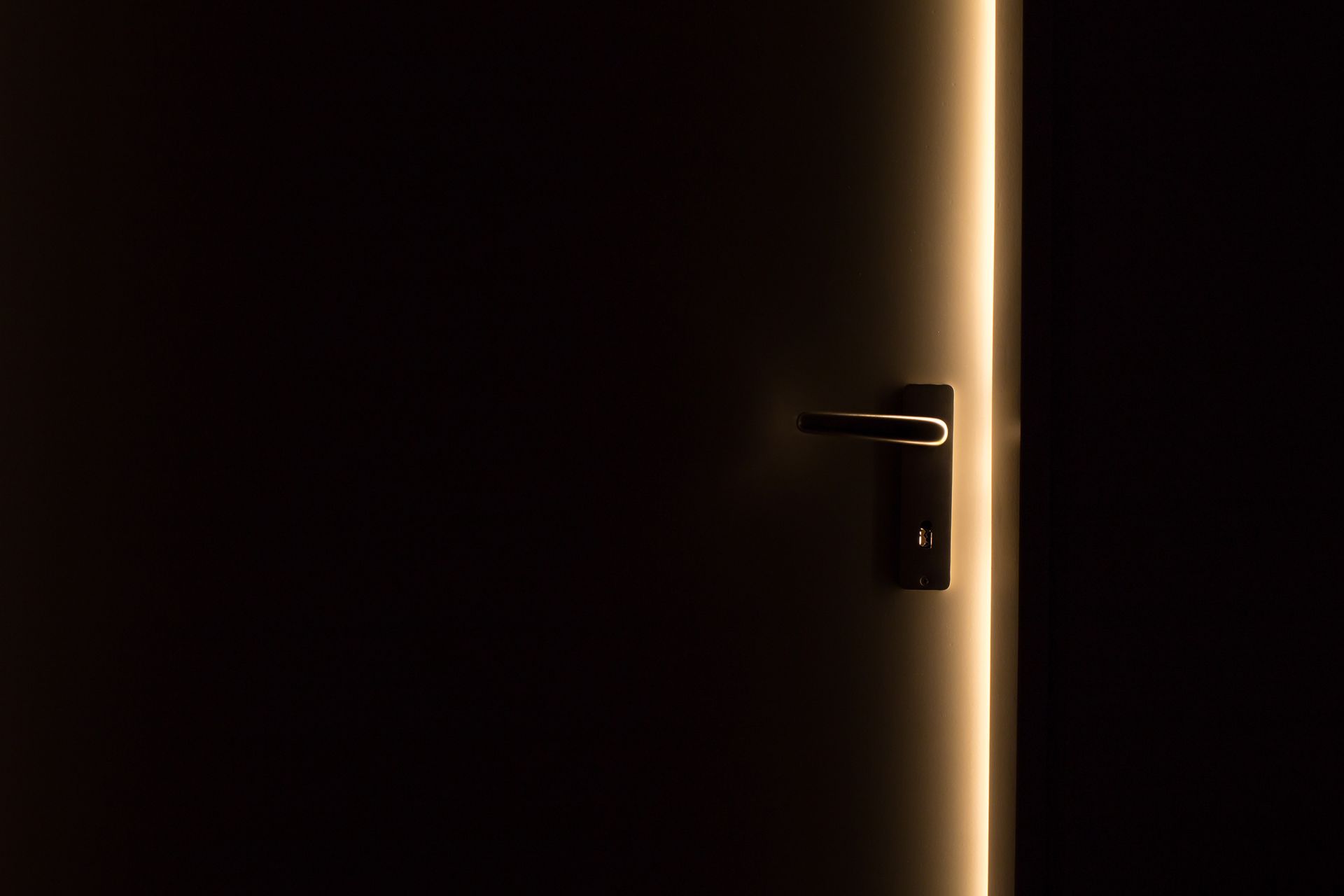 An open doorway spilling warm light into a dim room, symbolizing the new beginning that follows the endings of 999