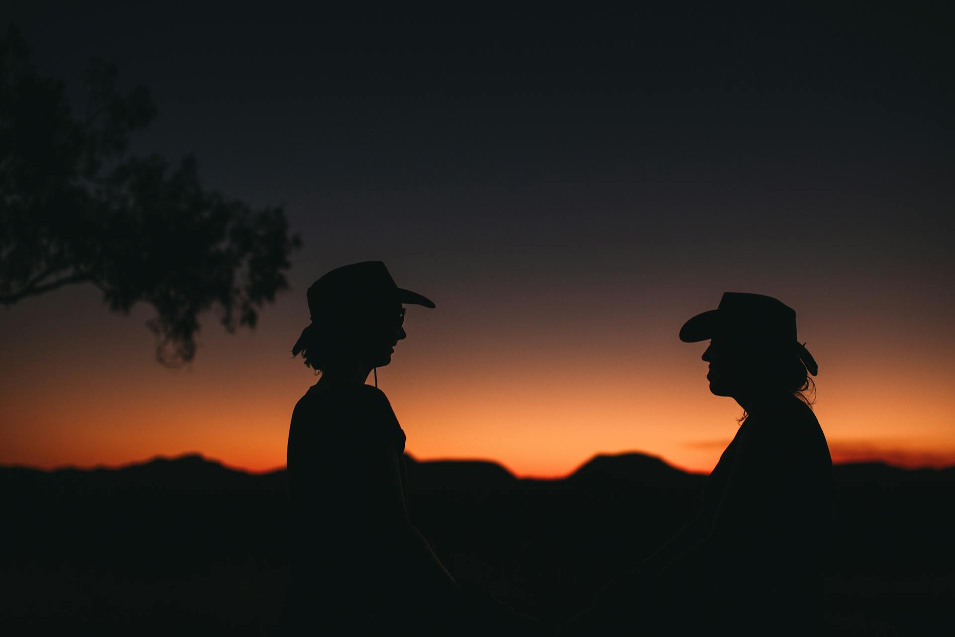 A group of friends silhouetted together at sunset, symbolizing the Aquarius gift for friendship, community, and belonging to something larger