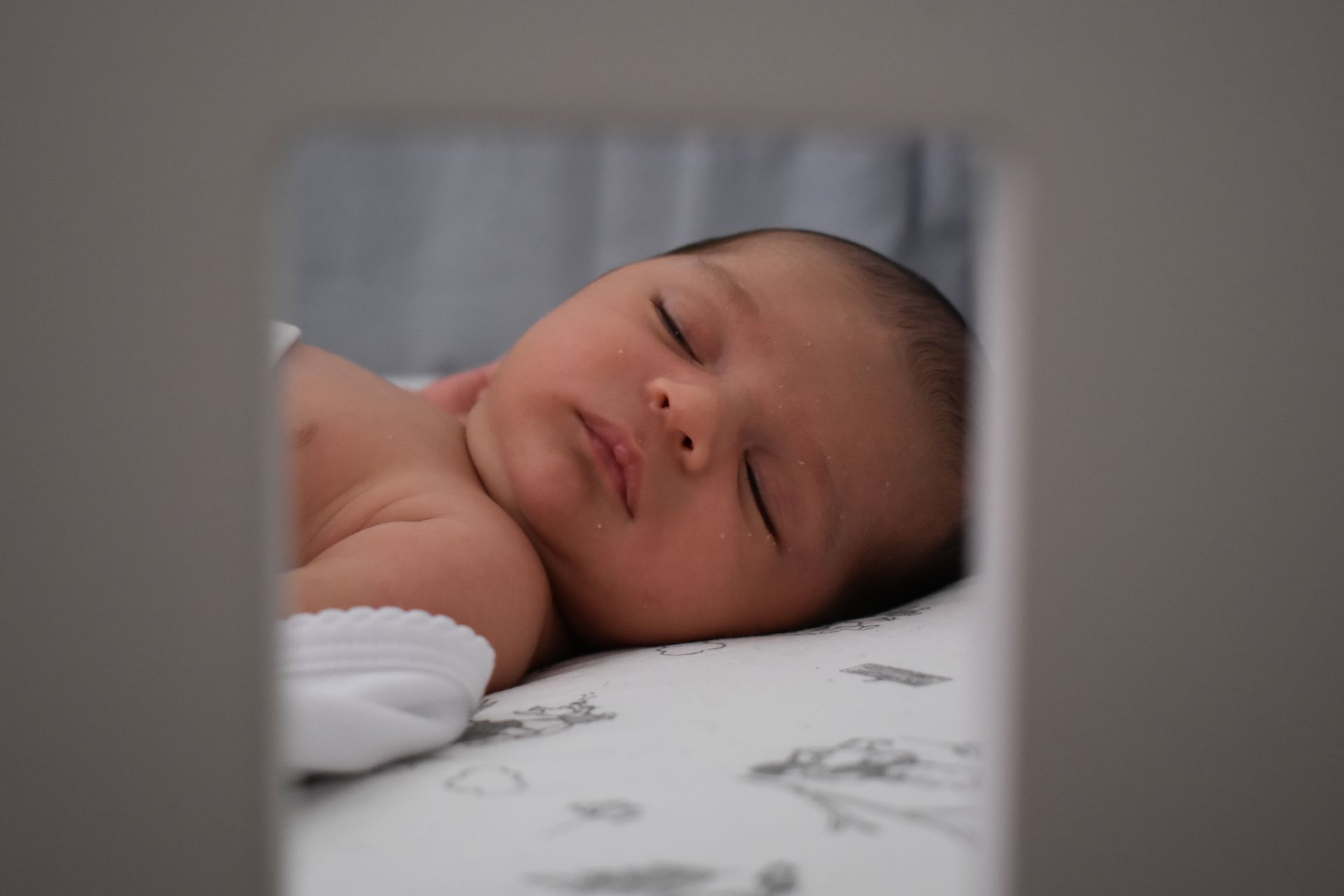 A newborn sleeping peacefully in soft light, illustrating the tenderness and new-beginnings symbolism behind baby dream meaning
