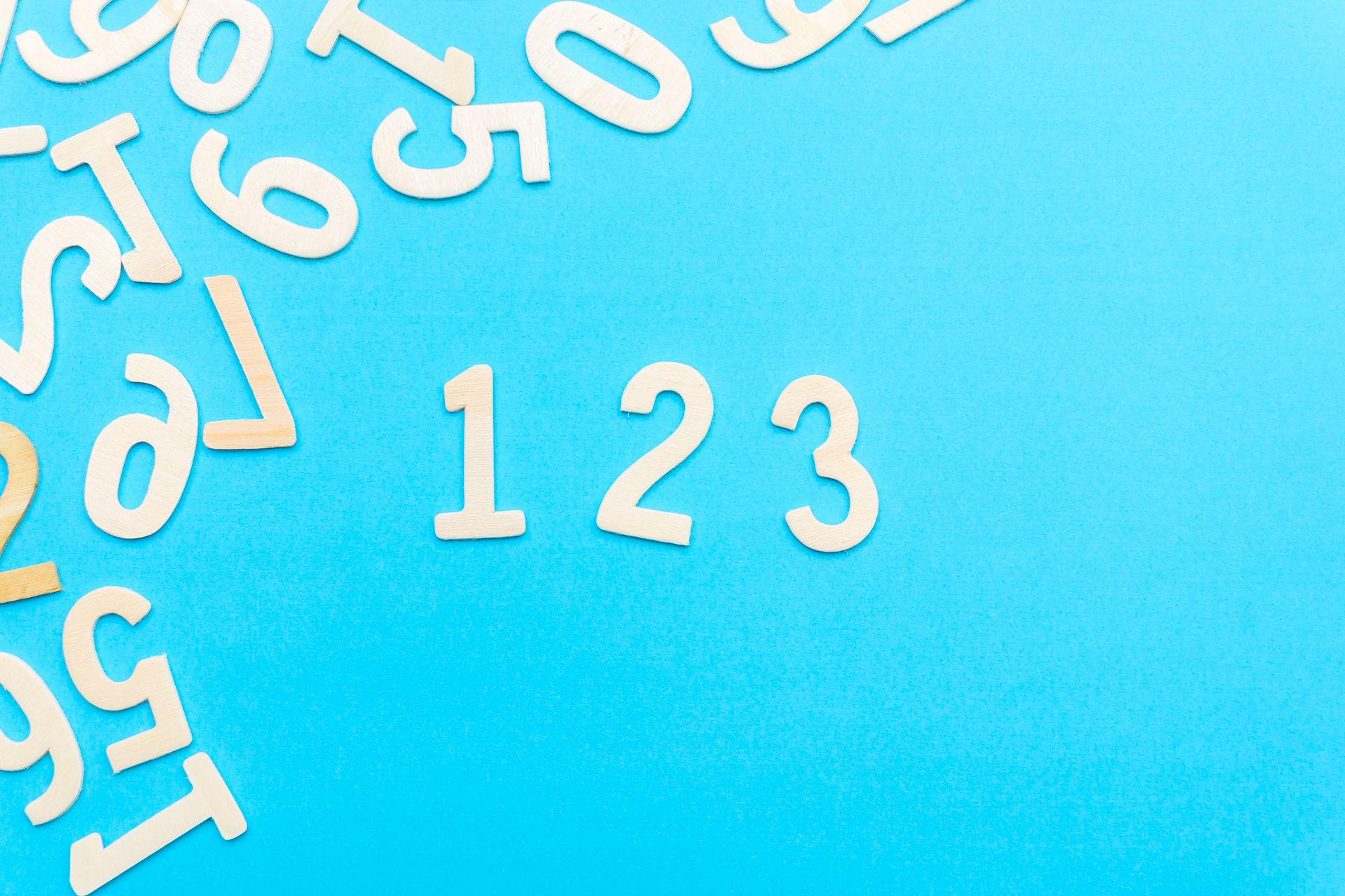 A calculator and notepad with handwritten numbers, representing the simple calculation behind the numerology birthday number