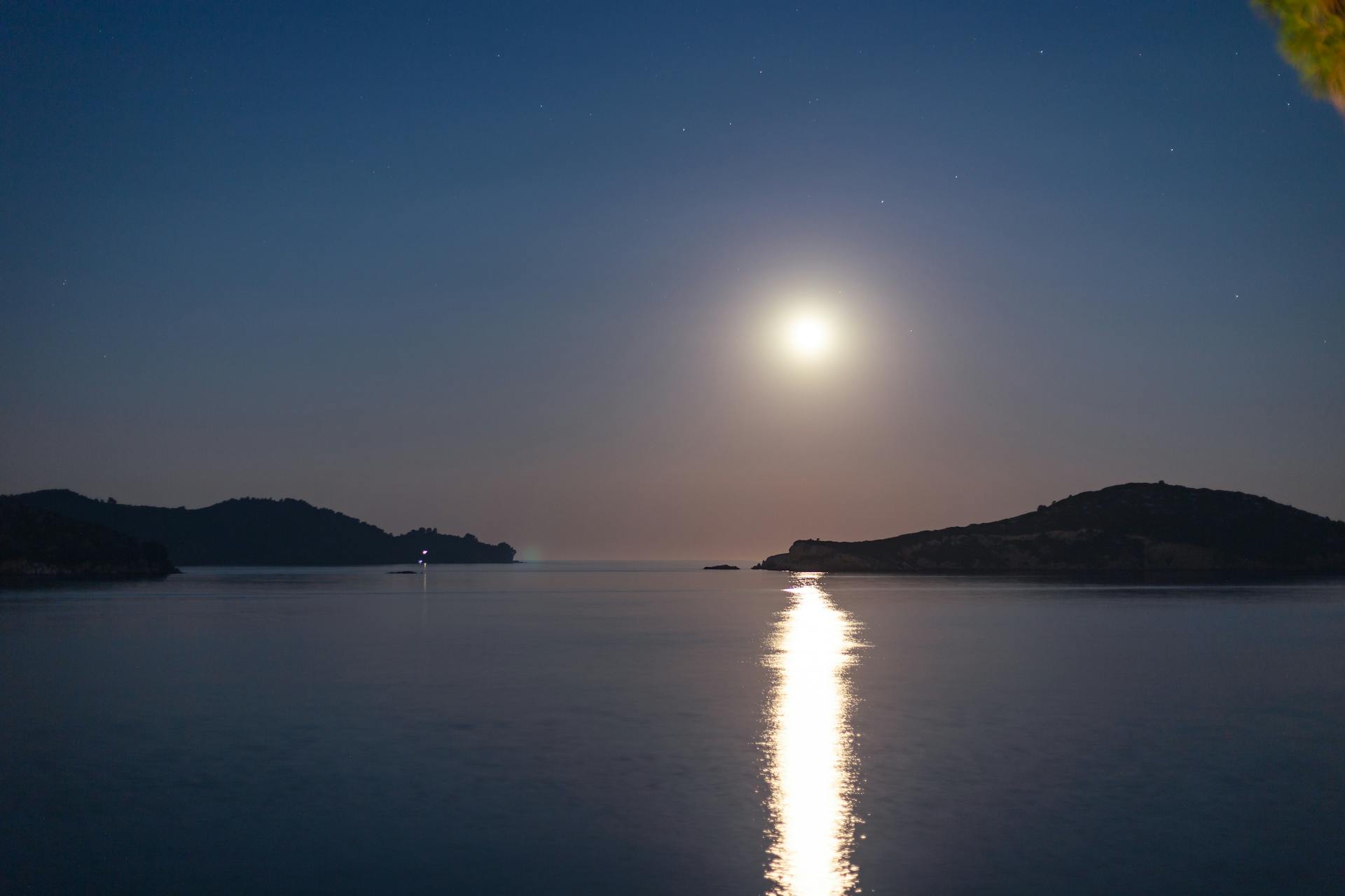 Moonlight reflecting across the dark, rippling surface of a quiet sea, evoking the deep emotional inner world of Cancer