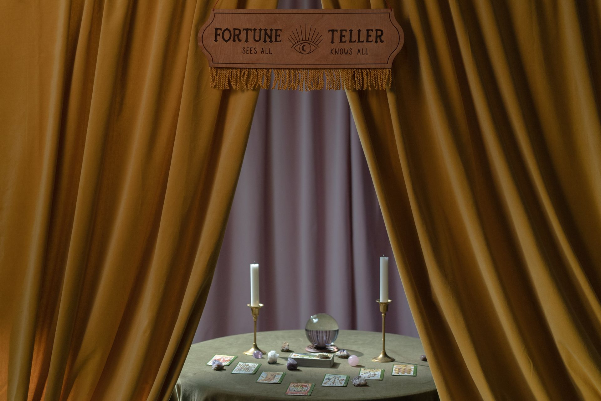 A person doing a card reading at a candlelit table, practicing cartomancy in a quiet setting