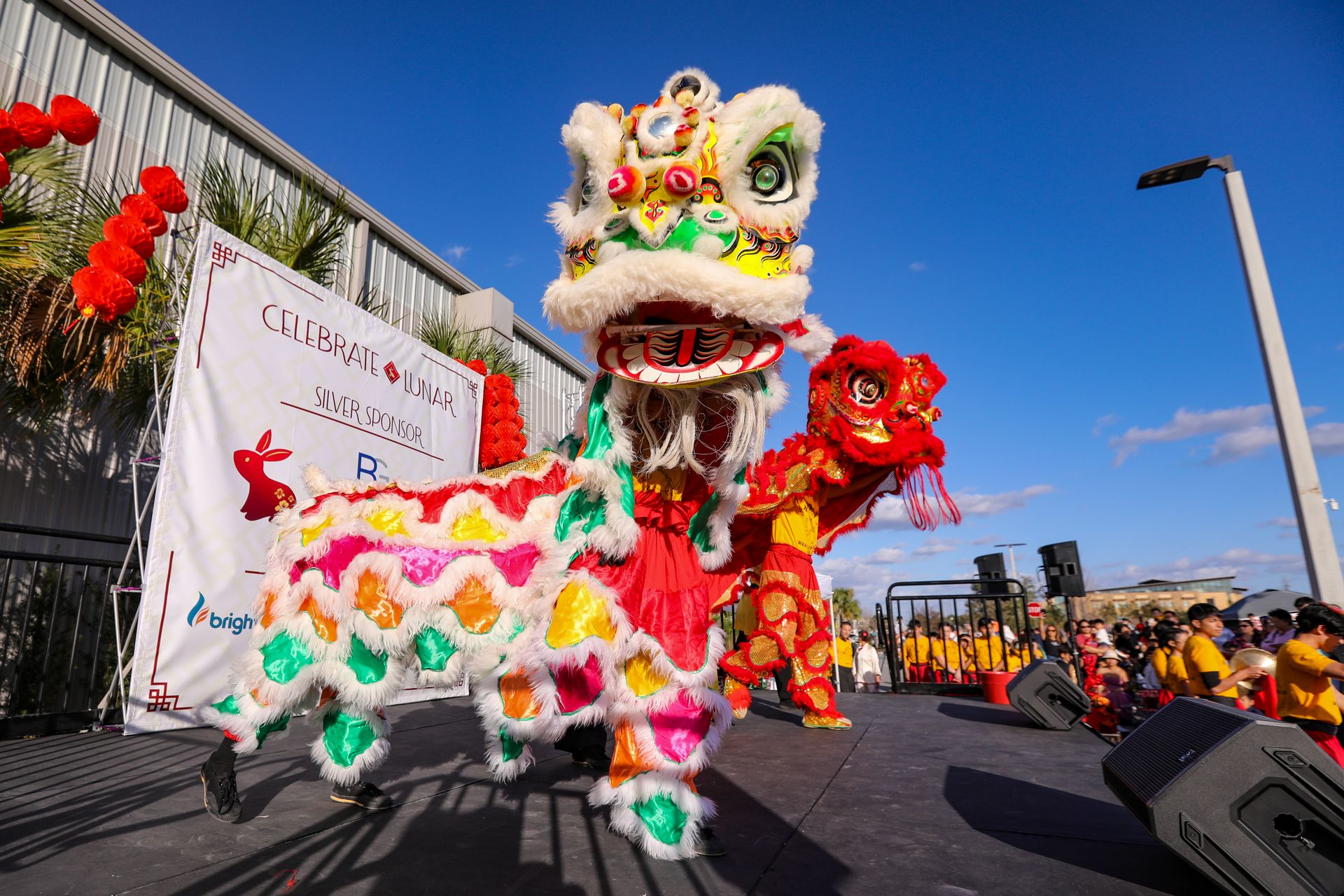 A crowded lunar new year celebration with red decorations and lights