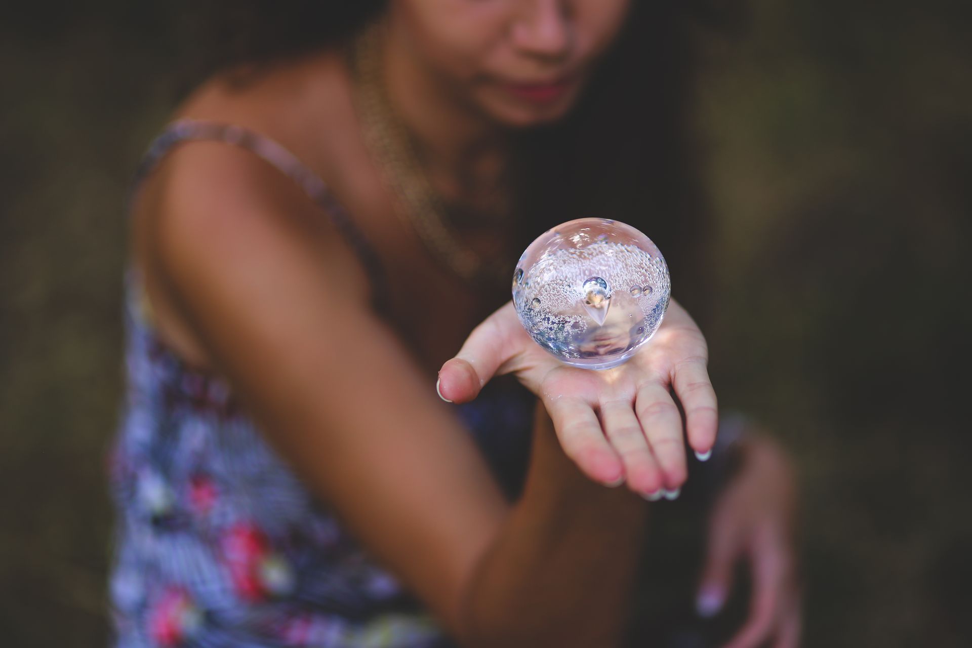 A woman cradling a glowing crystal ball in her hands, symbolizing clairvoyant inner sight