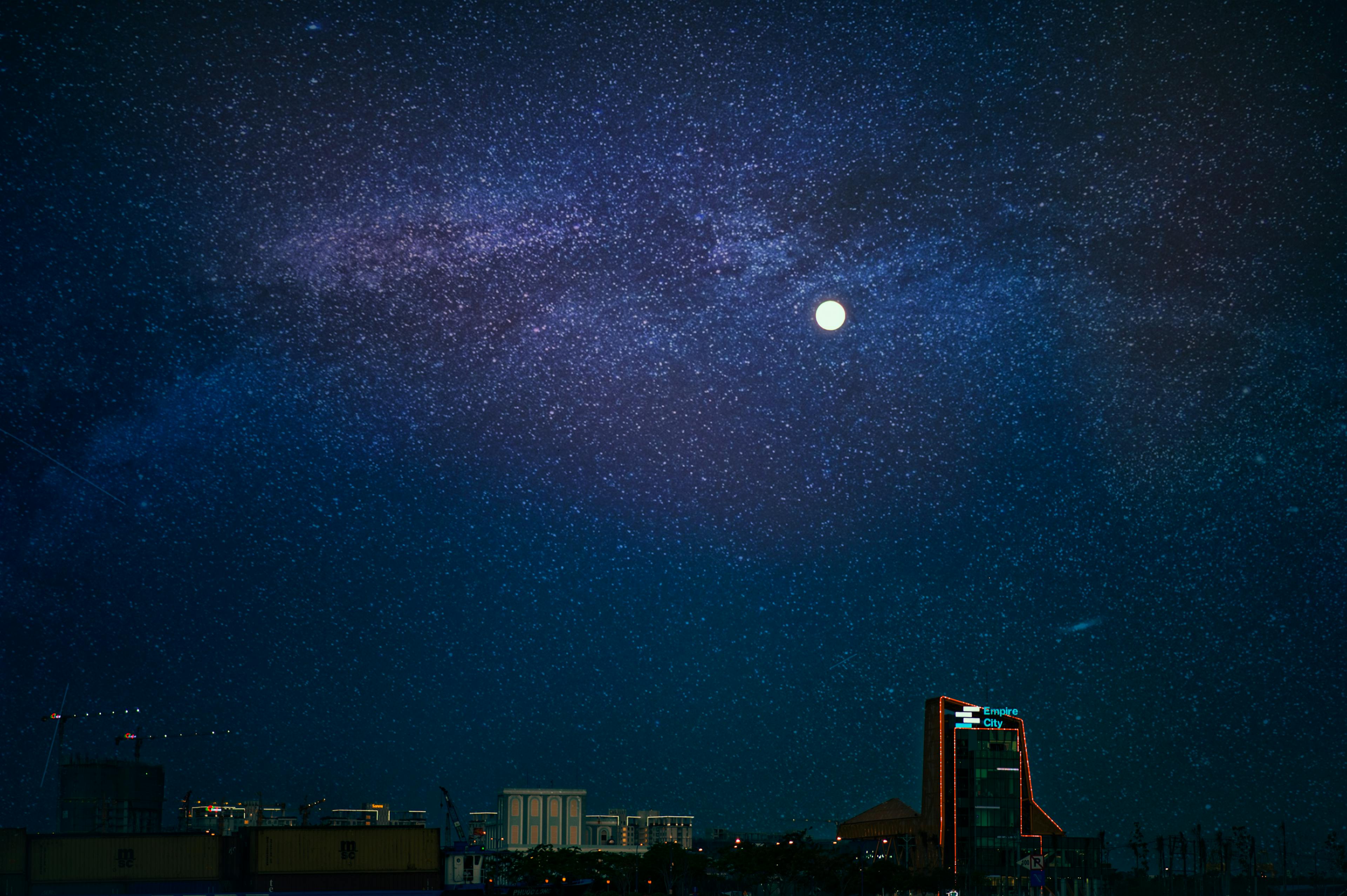 A deep starry night sky stretching over a dark horizon, representing the vast inner world the mind enters during sleep