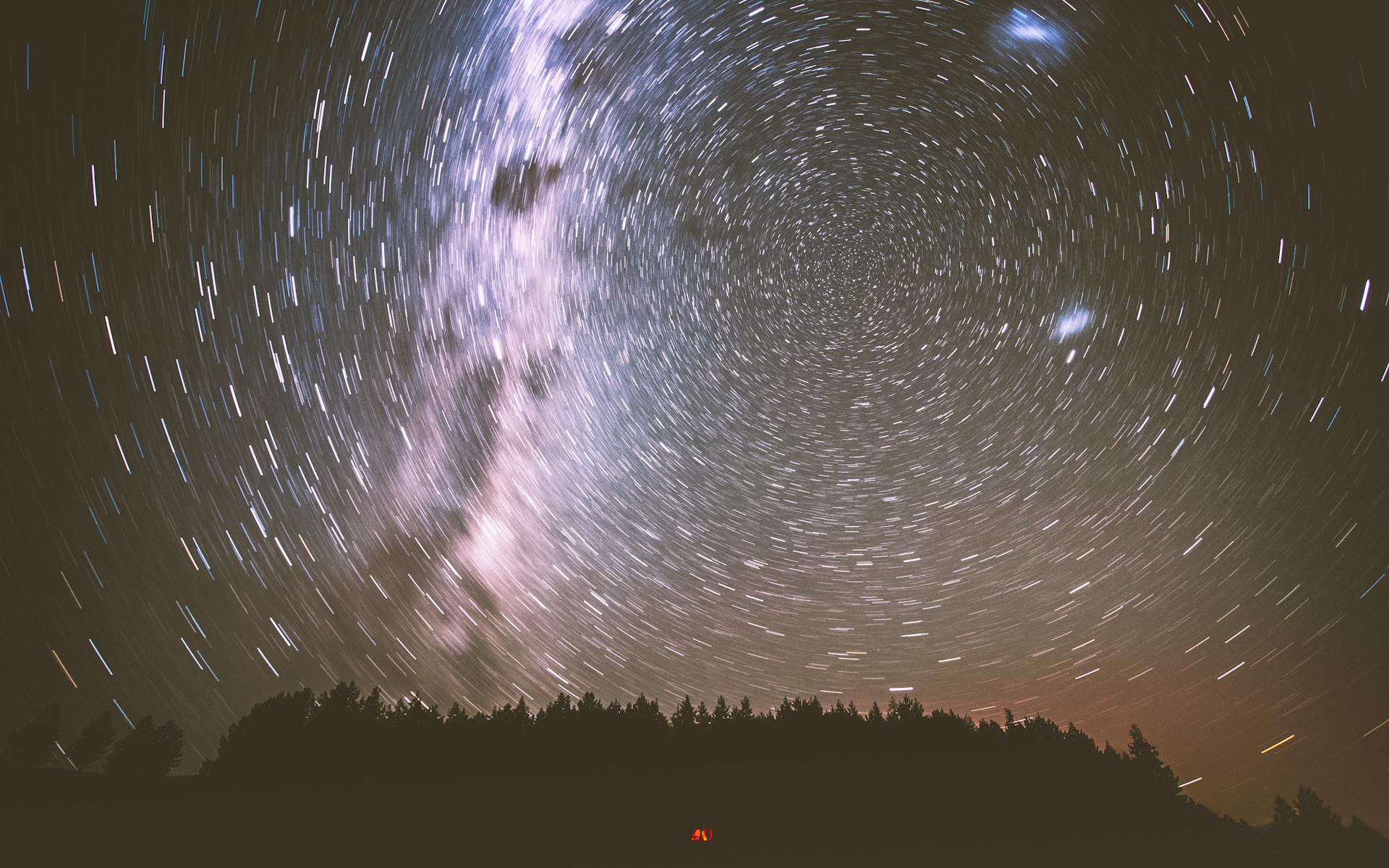 Star-filled night sky over a calm landscape representing the quiet but present energy of empty astrological houses