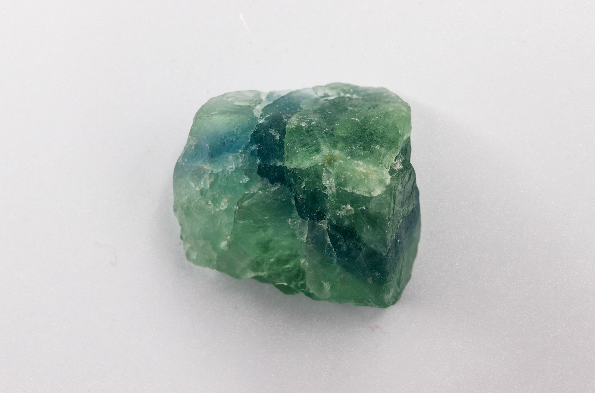 Polished fluorite crystal glowing in bands of purple and green, representing fluorite meaning and healing properties