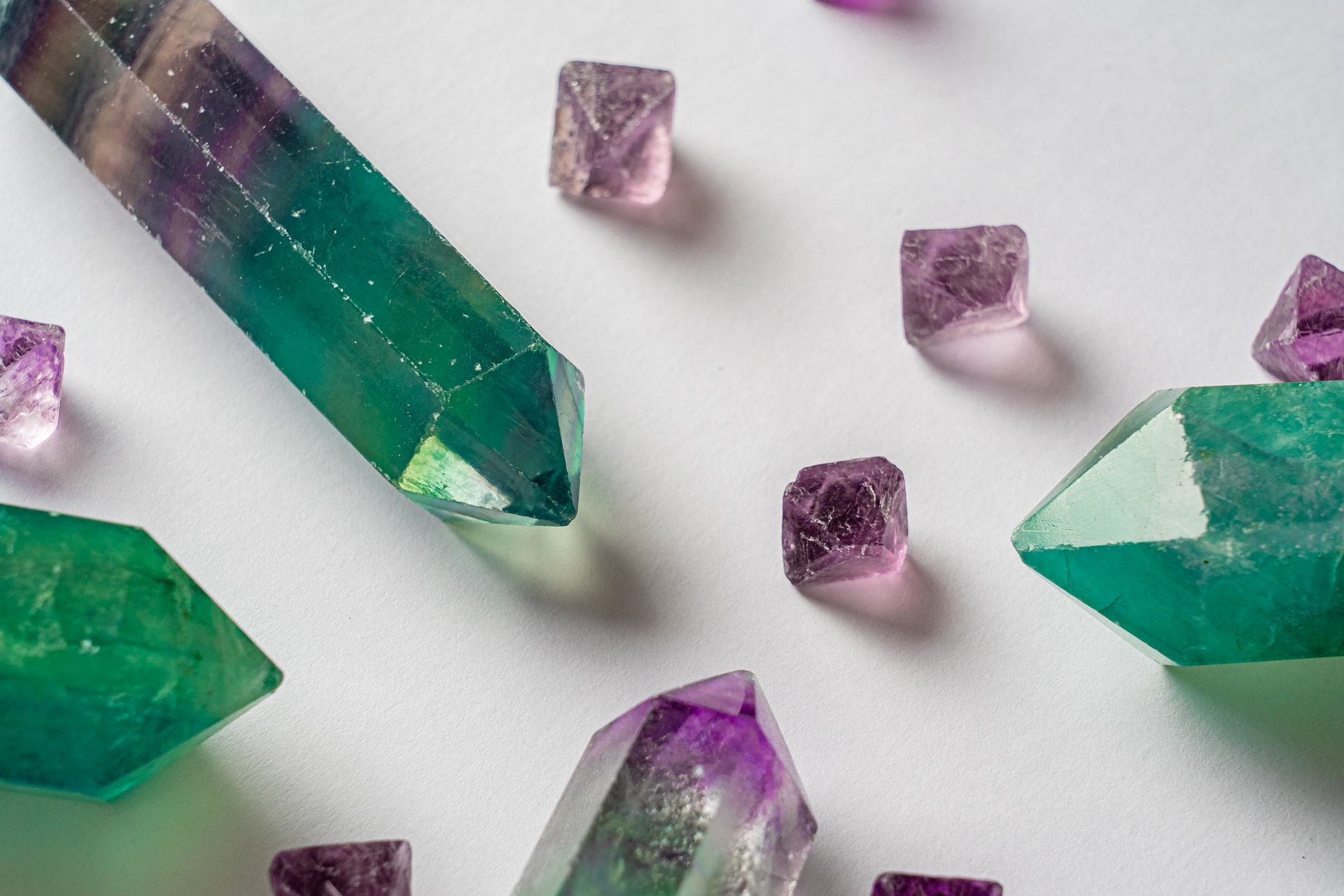 Fluorite crystal resting on a desk beside study notes, representing how to use fluorite for focus and concentration
