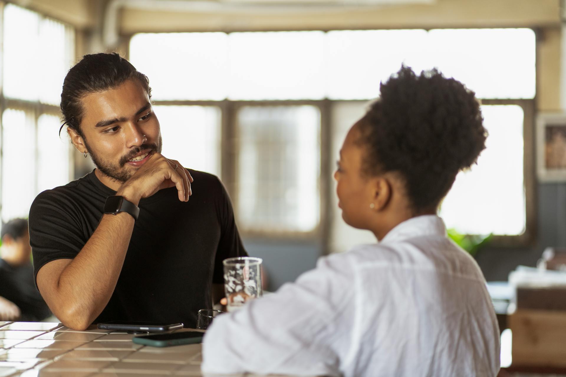 Two people deep in animated conversation, capturing Gemini's gift for communication and connection