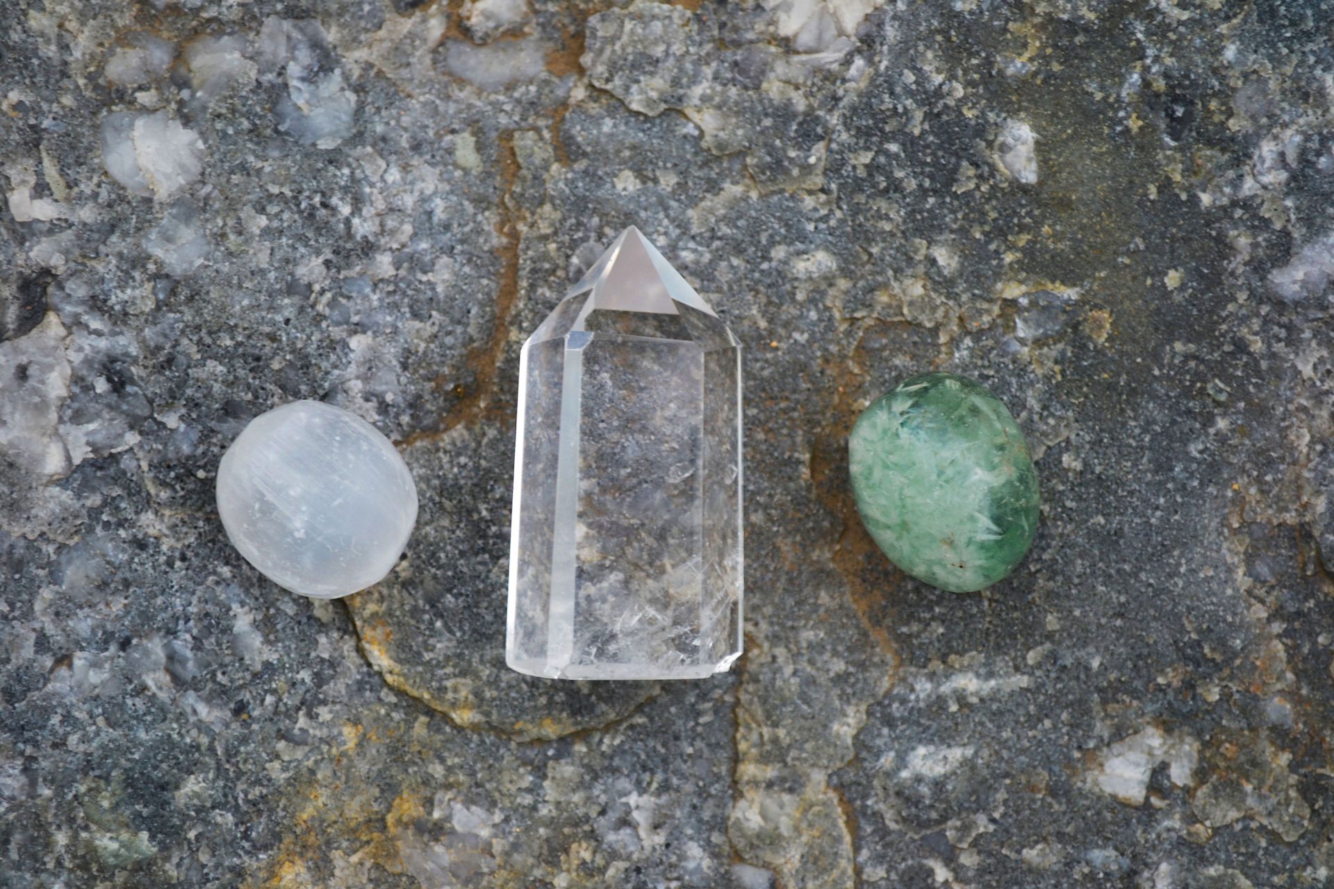 A piece of white selenite glowing in soft light, a stone often used to cleanse other crystals