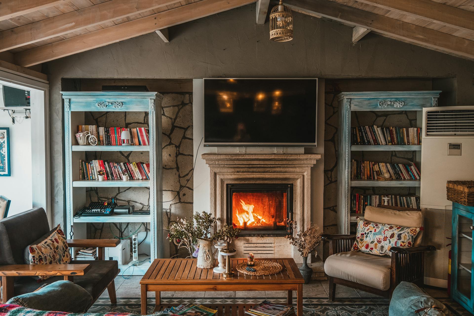 Warm and inviting living room with a cozy fireplace and decorative bookshelves representing the comfort and safety of the IC