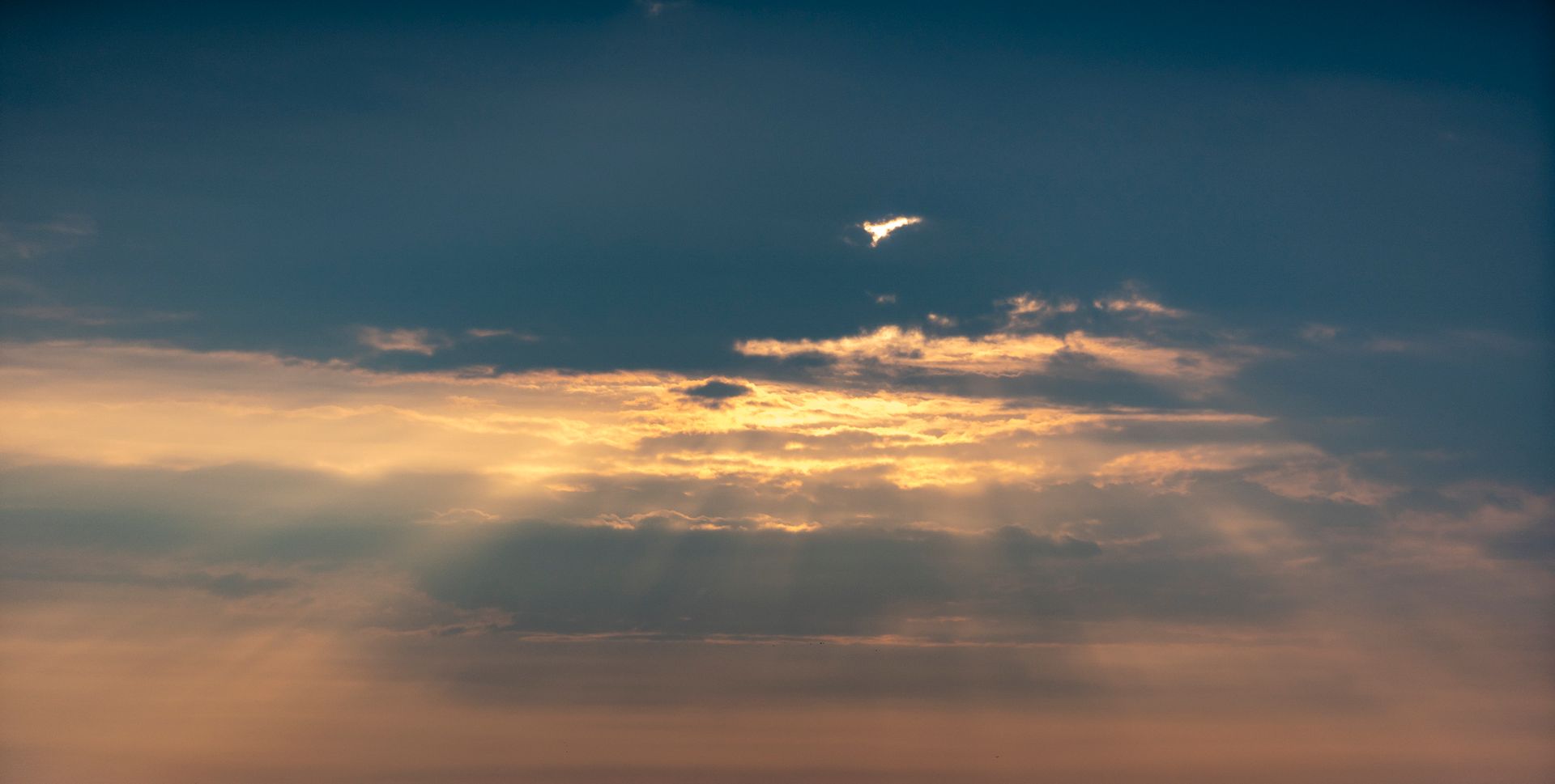 Warm golden sunlight streaming across a bright sky representing the optimism and generous energy of Jupiter in Leo