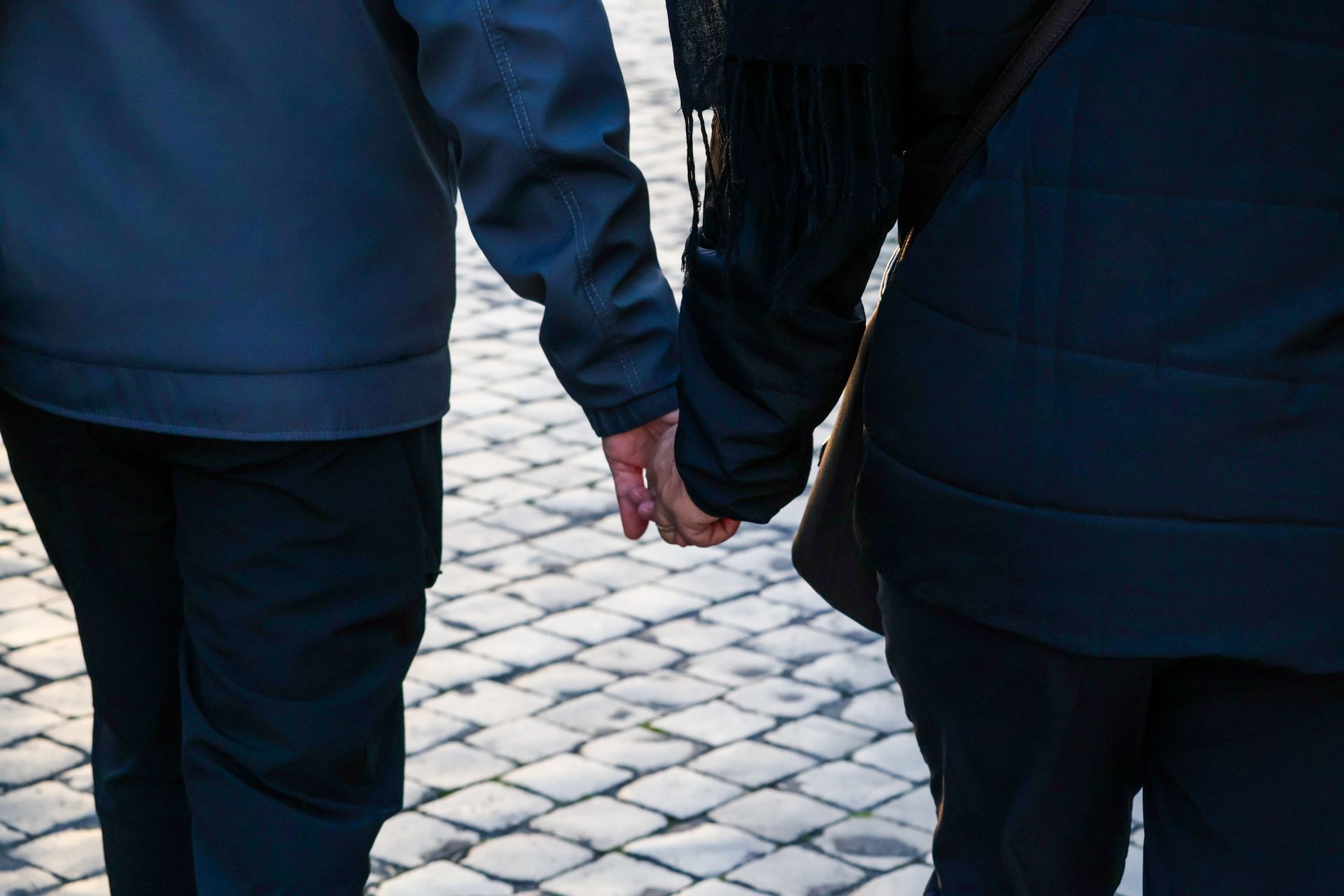 Two people holding hands across a table, representing Libra's deep orientation toward partnership, equality, and shared connection