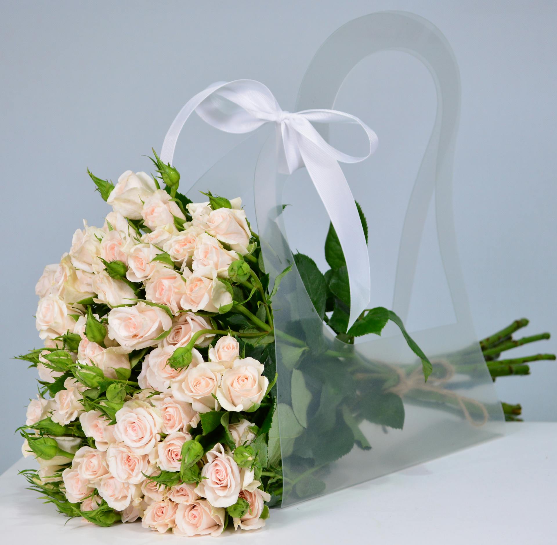 A vase of soft pink roses beside elegant decor, reflecting Libra's Venus-ruled love of beauty, refinement, and pleasing surroundings