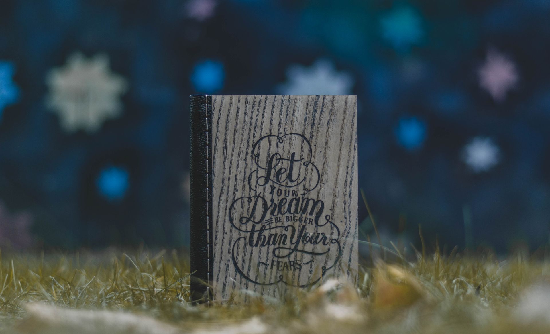 An open dream journal and pen on a bedside surface, used to record dreams for lucid dreaming practice