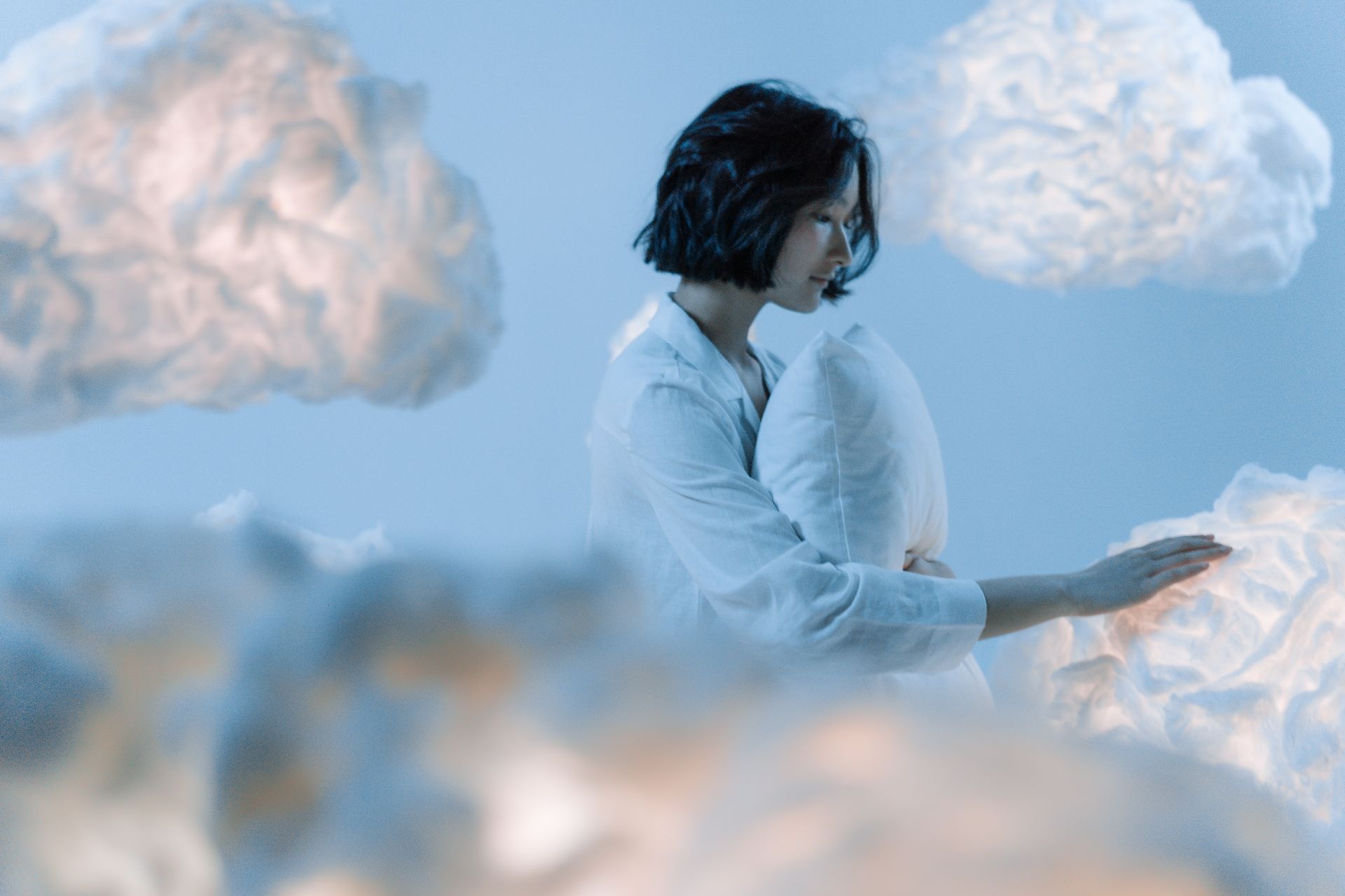 Surreal dreamlike clouds in soft light, representing the shifting scenery of a lucid dream