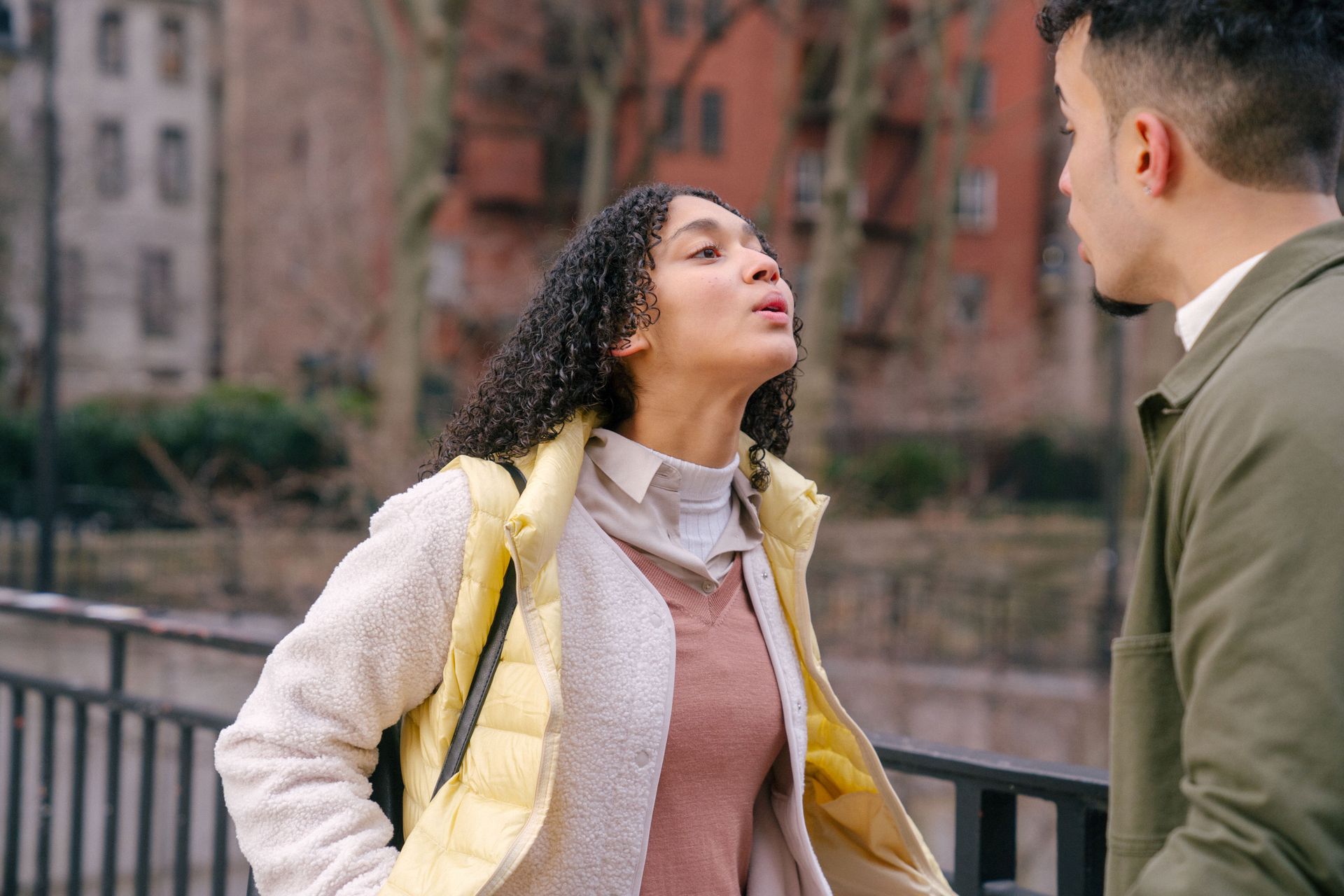 A couple sitting apart in a tense moment, representing the conflict styles revealed by Mars sign compatibility