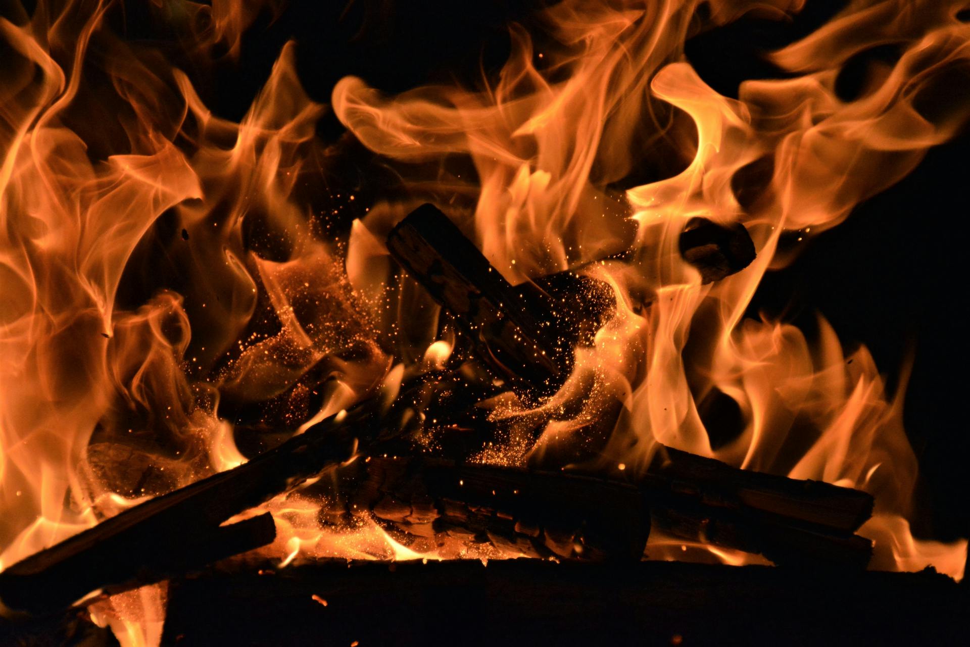 Flames rising against a dark background, representing the intense, all-or-nothing desire of fire and water Mars signs