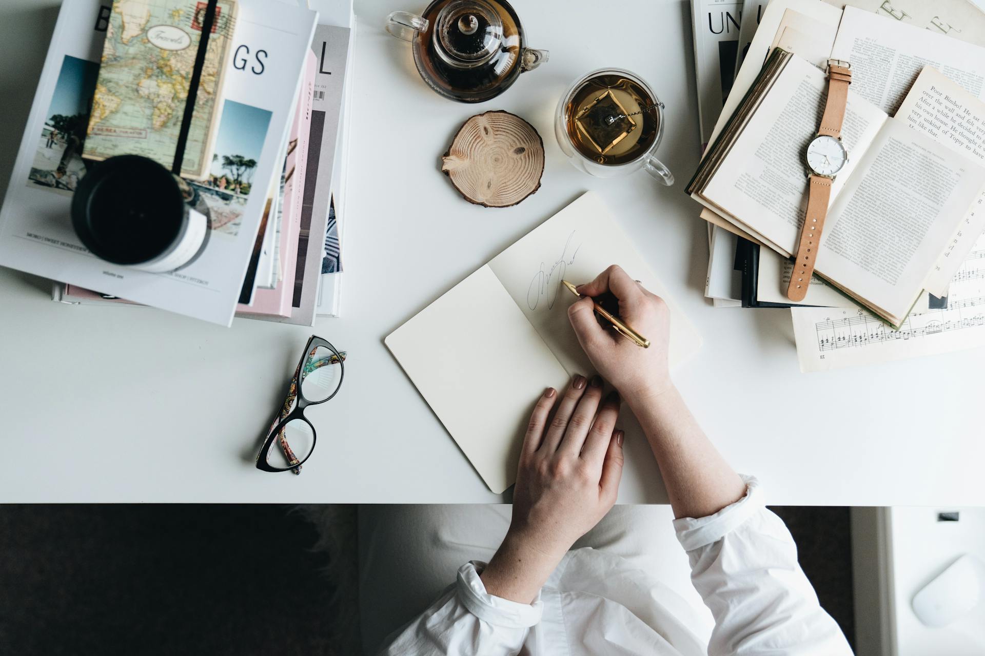 Journal and pen on a desk representing Mercury's connection to writing, communication, and daily mental activity