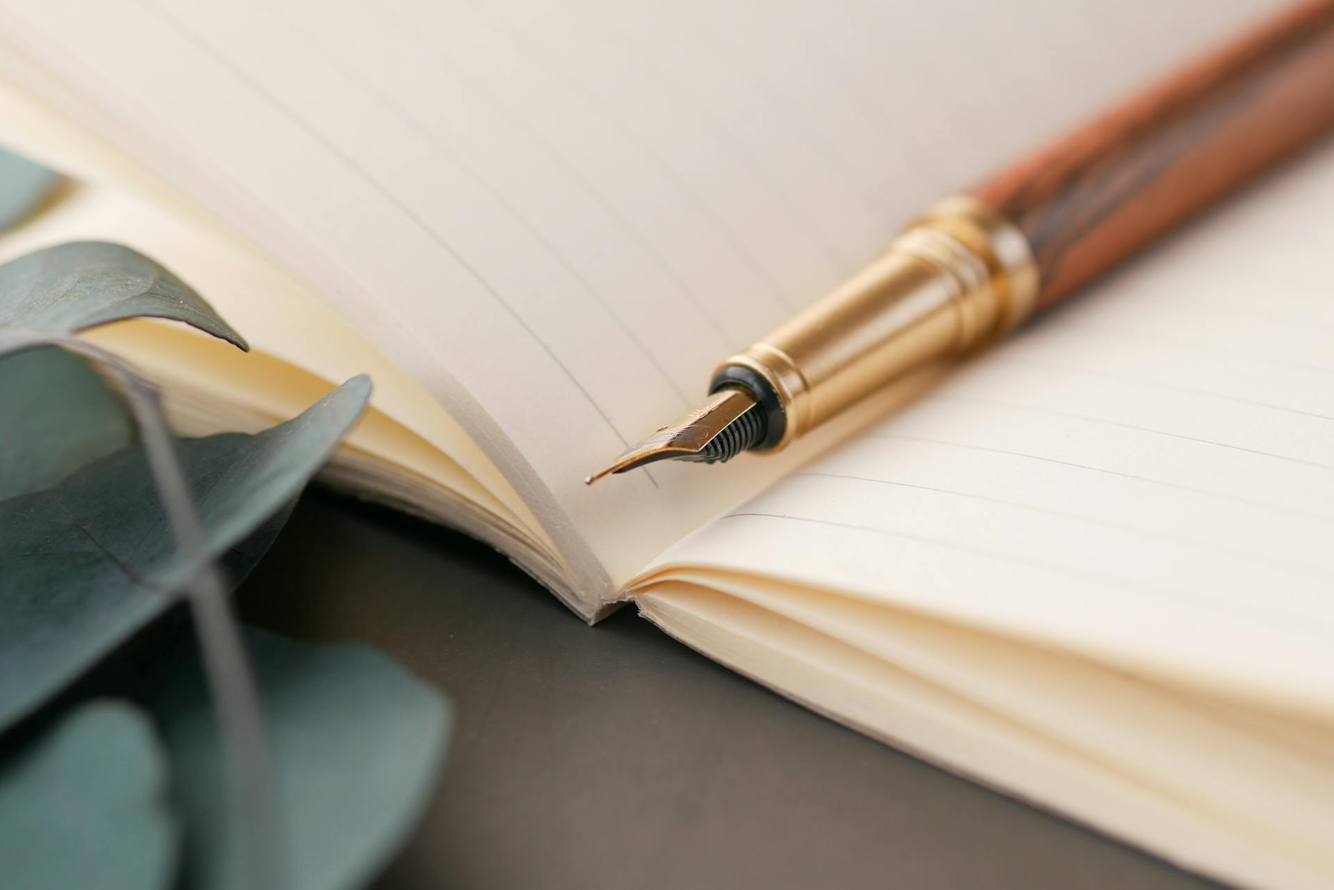 A closeup of a luxurious fountain pen resting on a lined notebook, capturing the art of written communication
