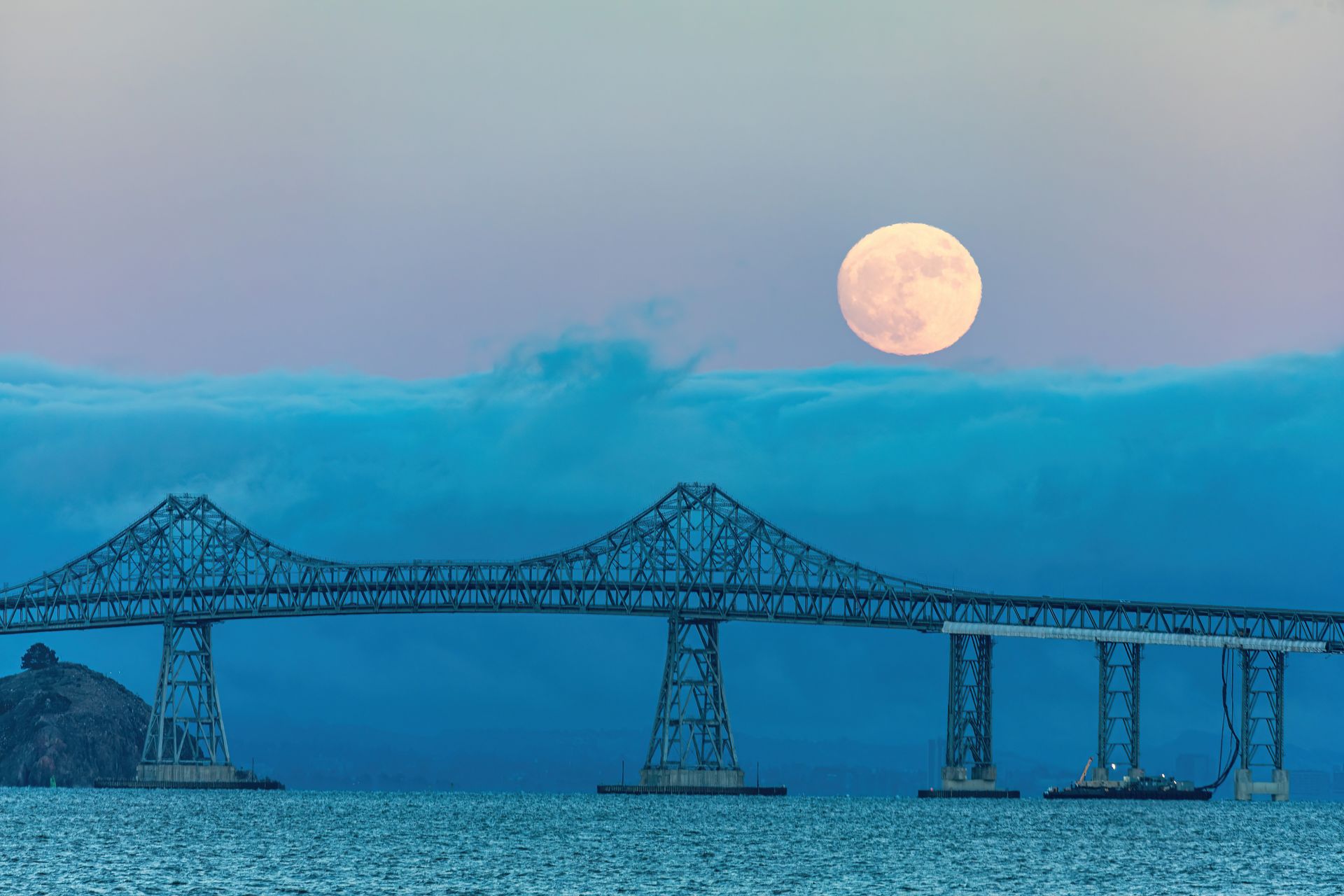 Moon reflecting over calm ocean water at night, symbolizing the emotional depth and instincts ruled by your moon sign