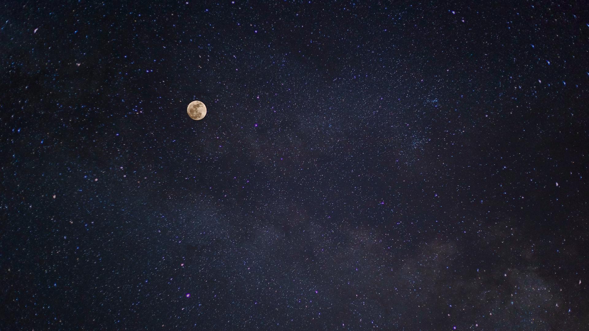 Full moon over a starry Milky Way sky representing the 27 nakshatras of Vedic astrology