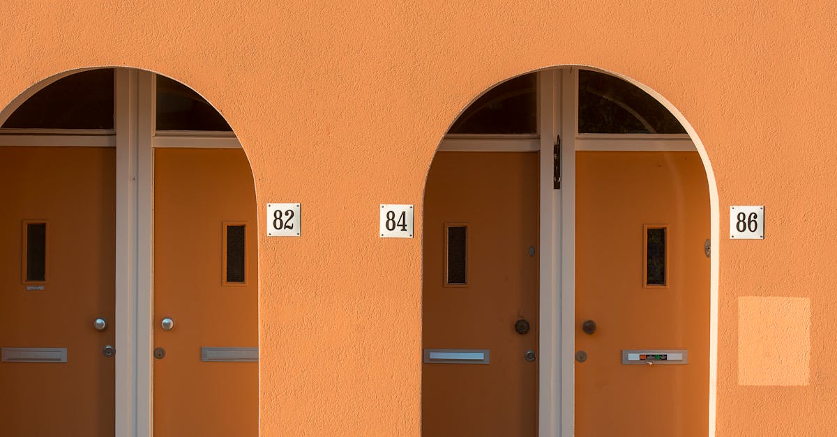 A set of metal house numbers mounted beside a front door, representing the meaning of your address in numerology