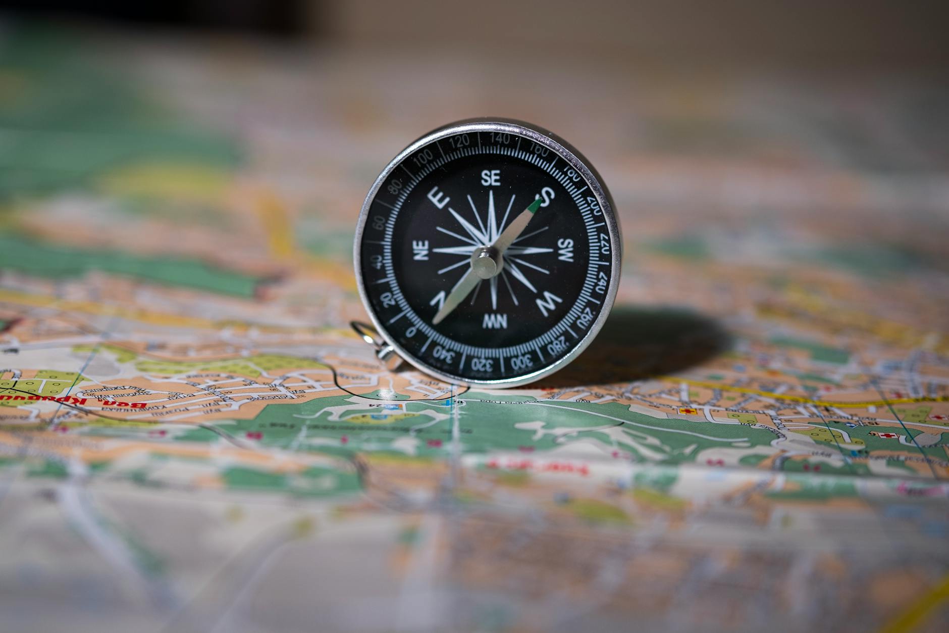 A compass laying on an old map symbolizing navigation beyond established boundaries and uncharted territory