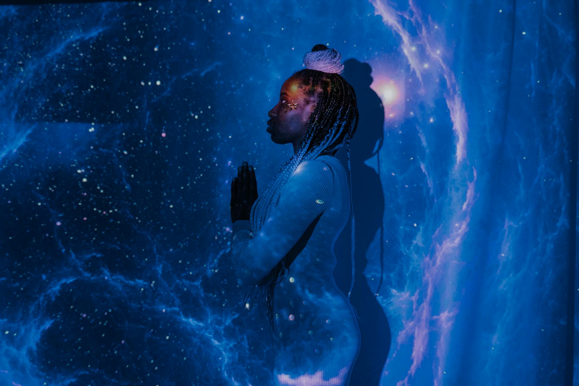 A silhouette of a woman against a starry cosmos representing the outer impression of the Personality Number in numerology