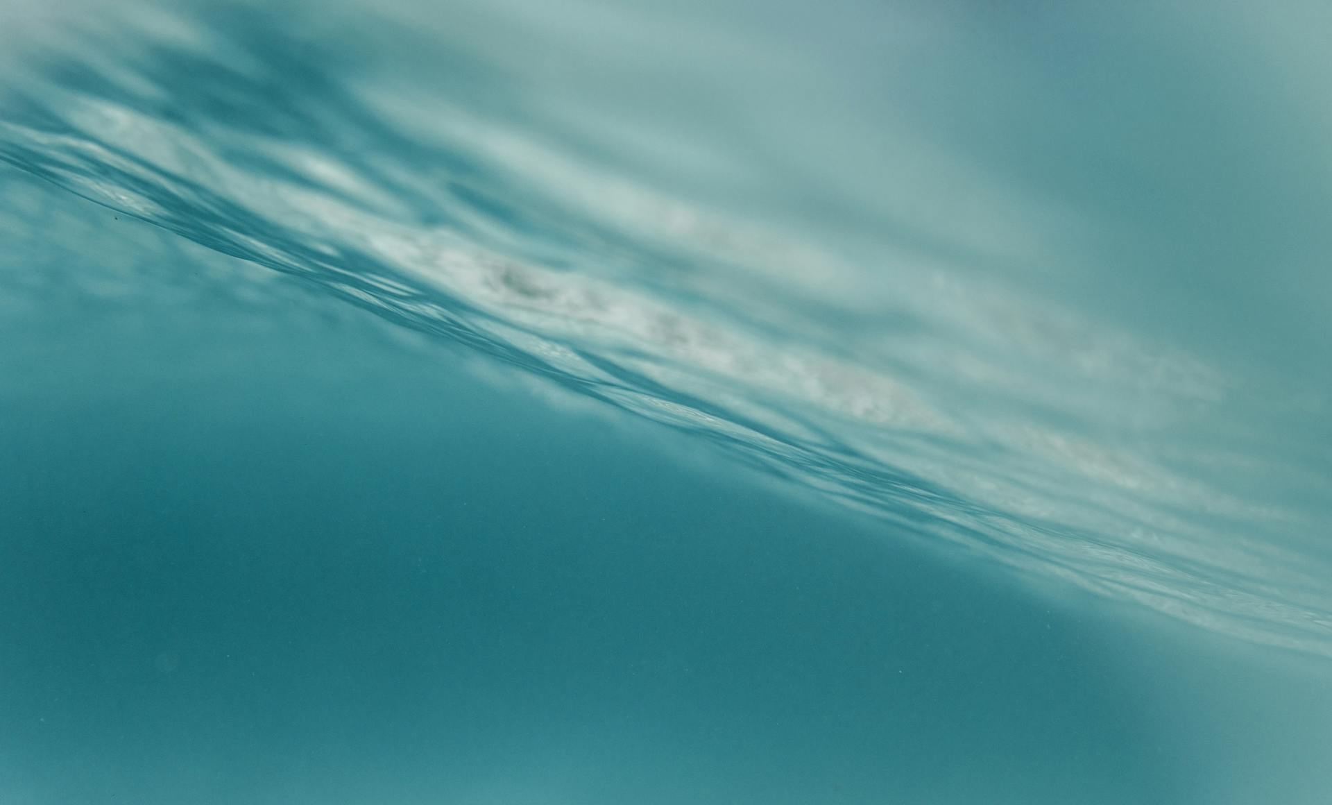 Light filtering through gentle underwater waves, capturing the dreamy, intuitive, boundary-dissolving nature of the Pisces mind