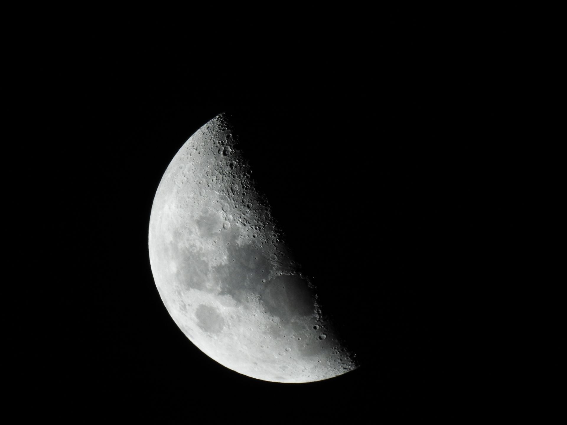 The Moon glowing against a deep black sky