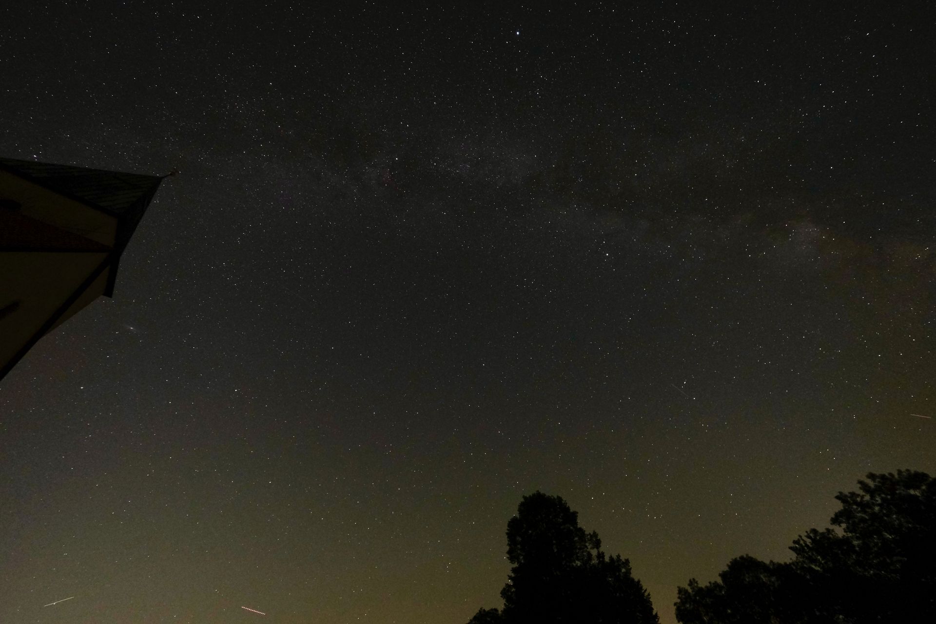 A clear night sky scattered with bright stars above a dark horizon