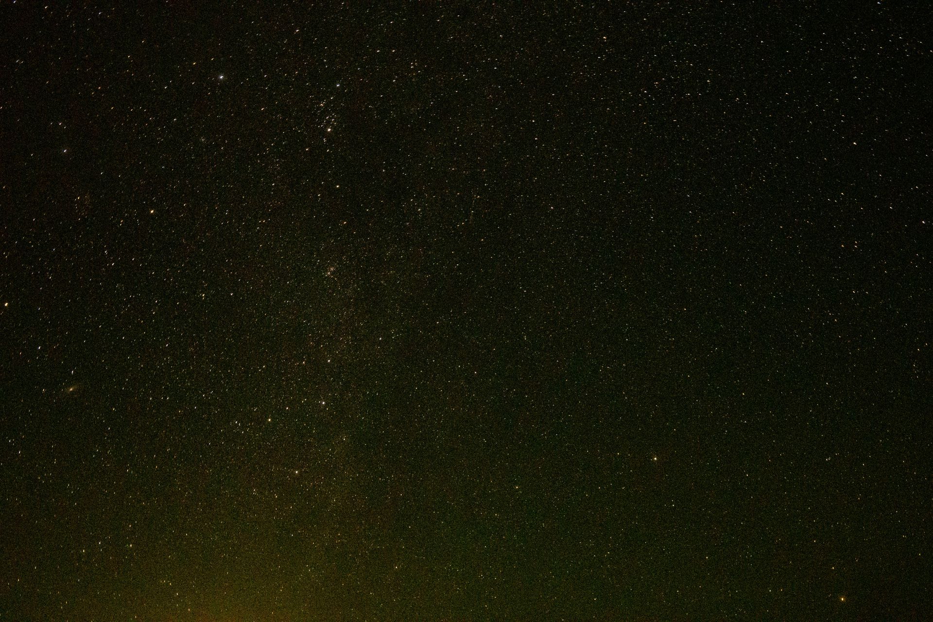 A telescope pointed at a star-filled night sky