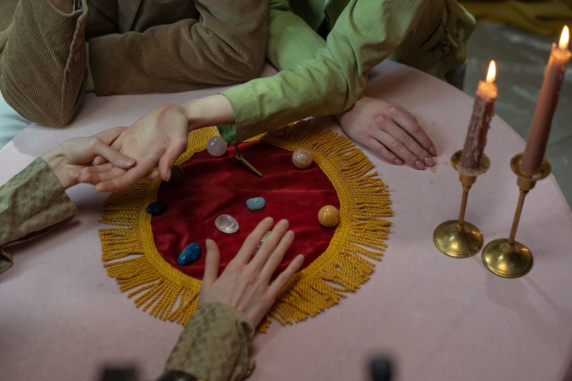 A close view of a healer's hands offering reiki energy just above a person's body