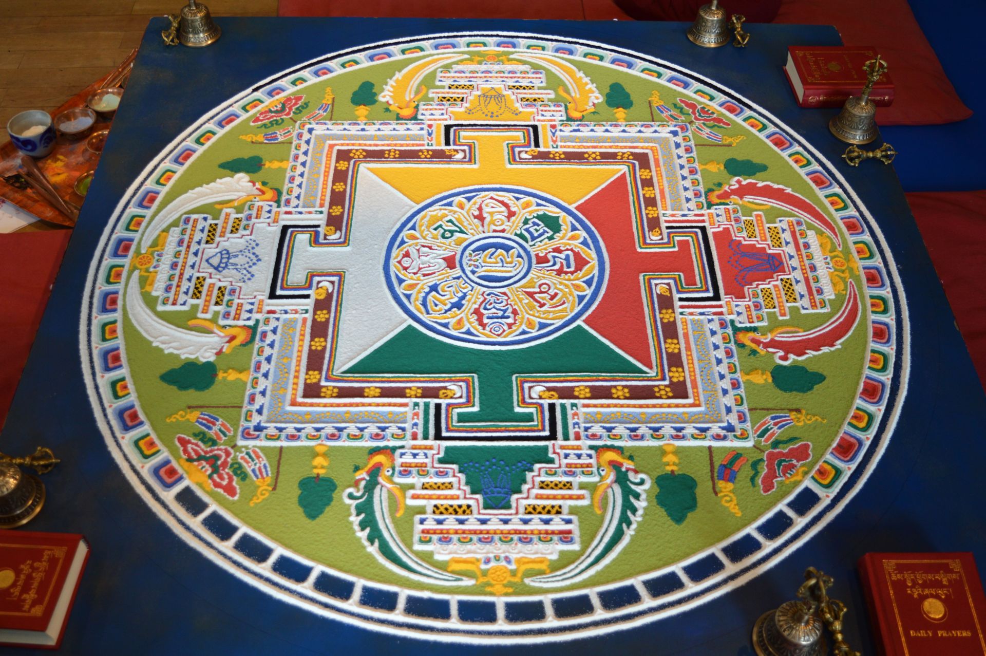 A colorful Tibetan sand mandala, one of the most intricate examples of sacred geometry, arranged in concentric circles and squares